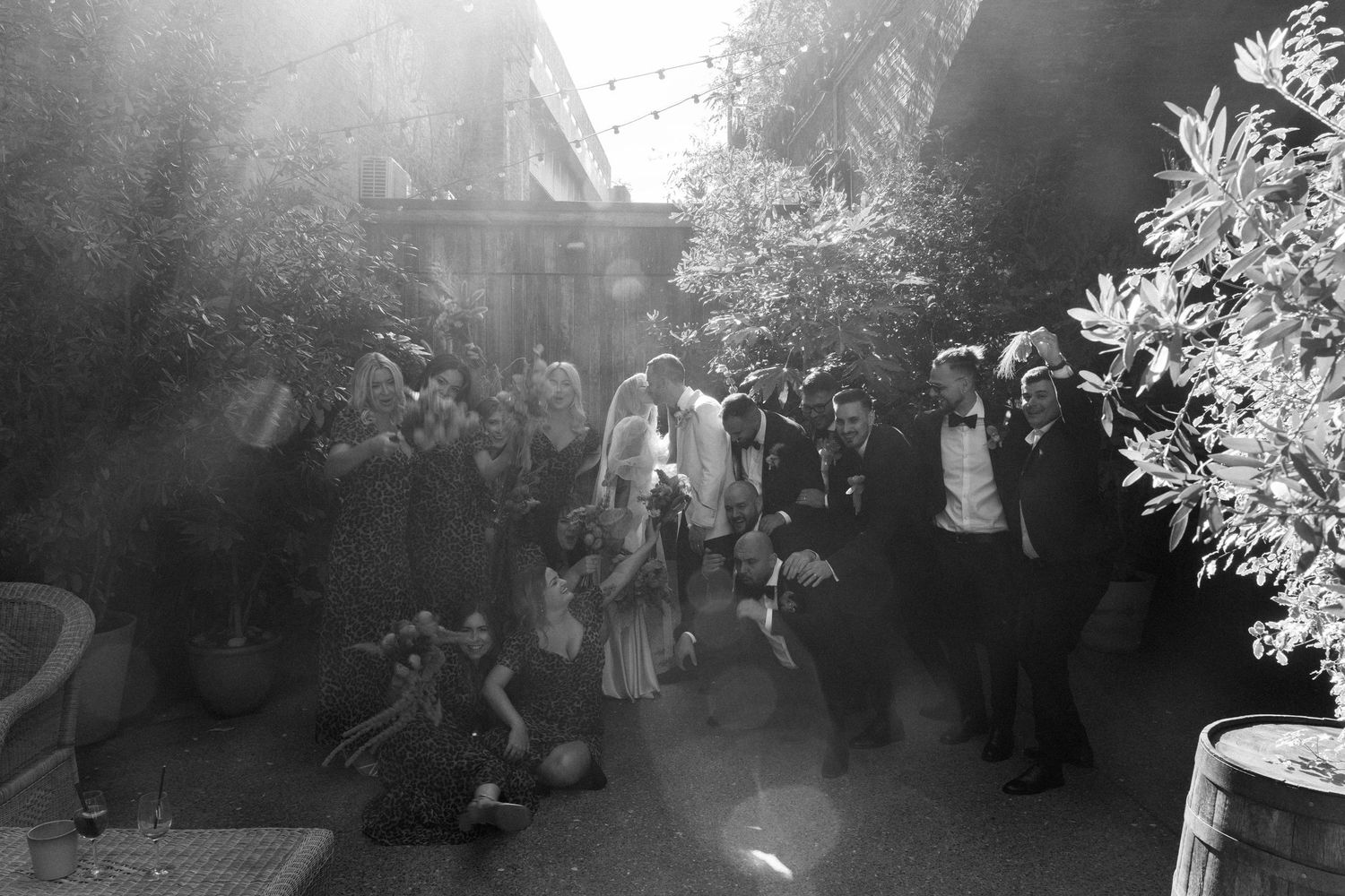 Wedding party dances and celebrates during golden hour outdoor reception.