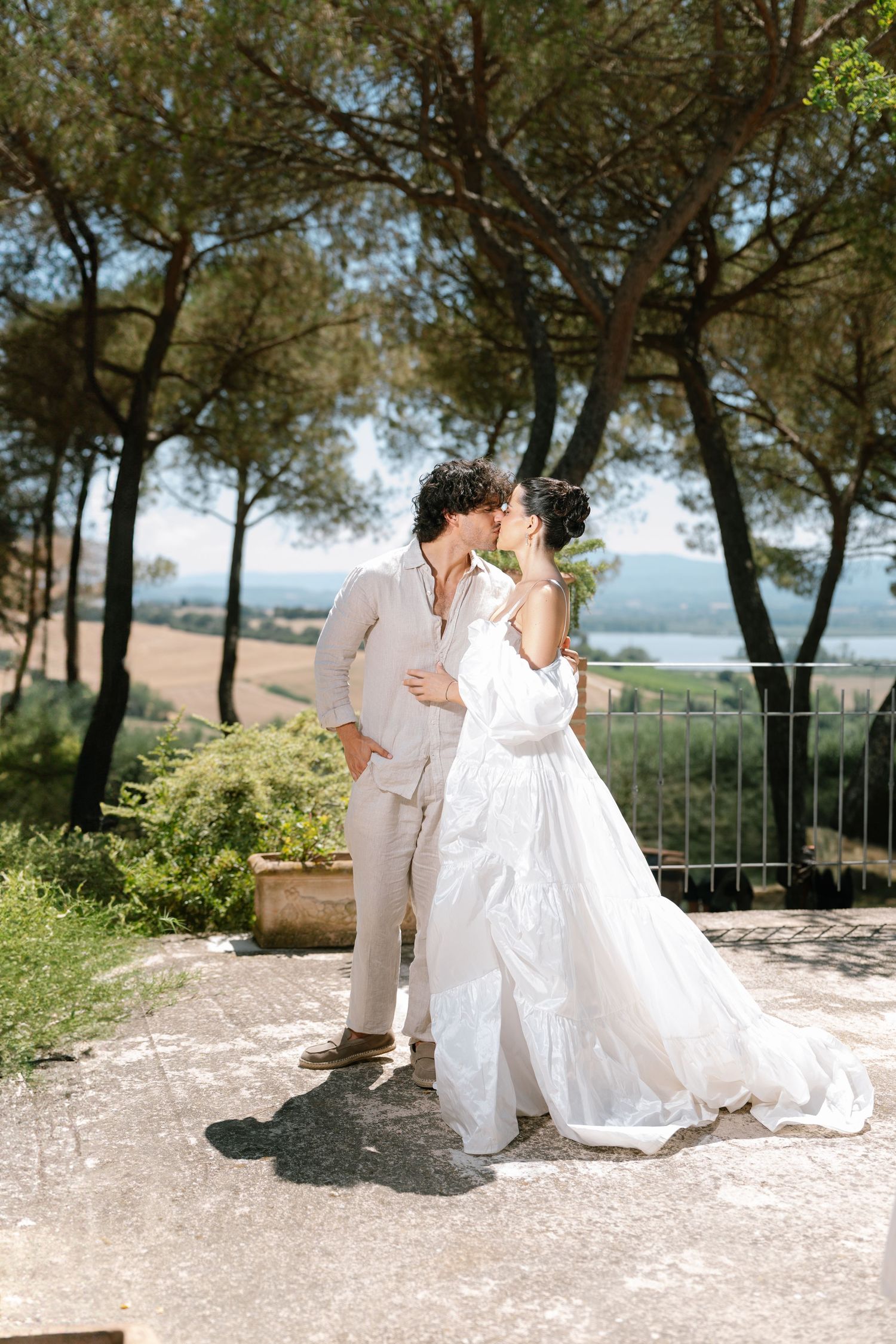 Intimate wedding couple moment captured in a scenic outdoor garden setting.
