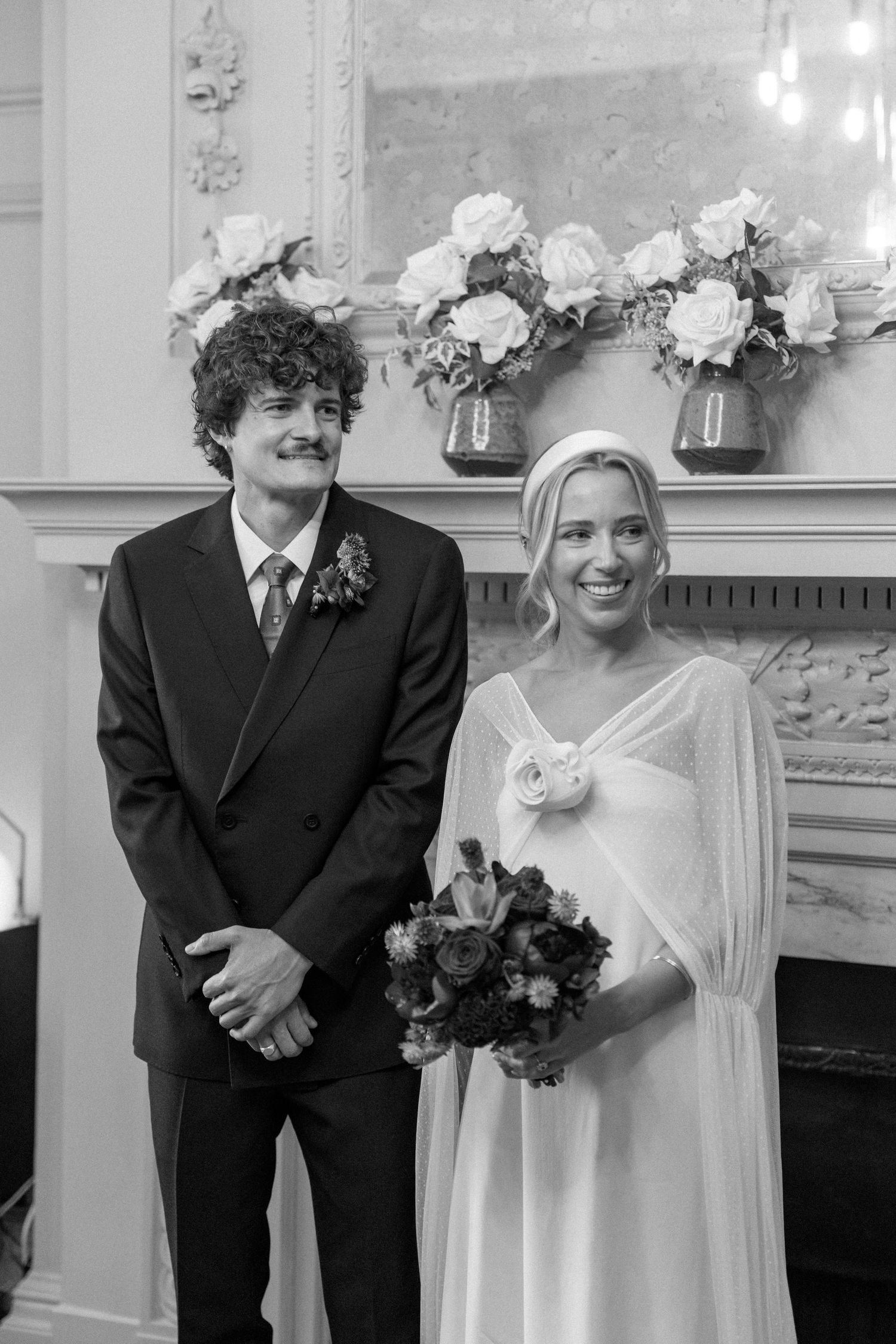 Black and white wedding portrait showing joyful moments during an intimate ceremony.