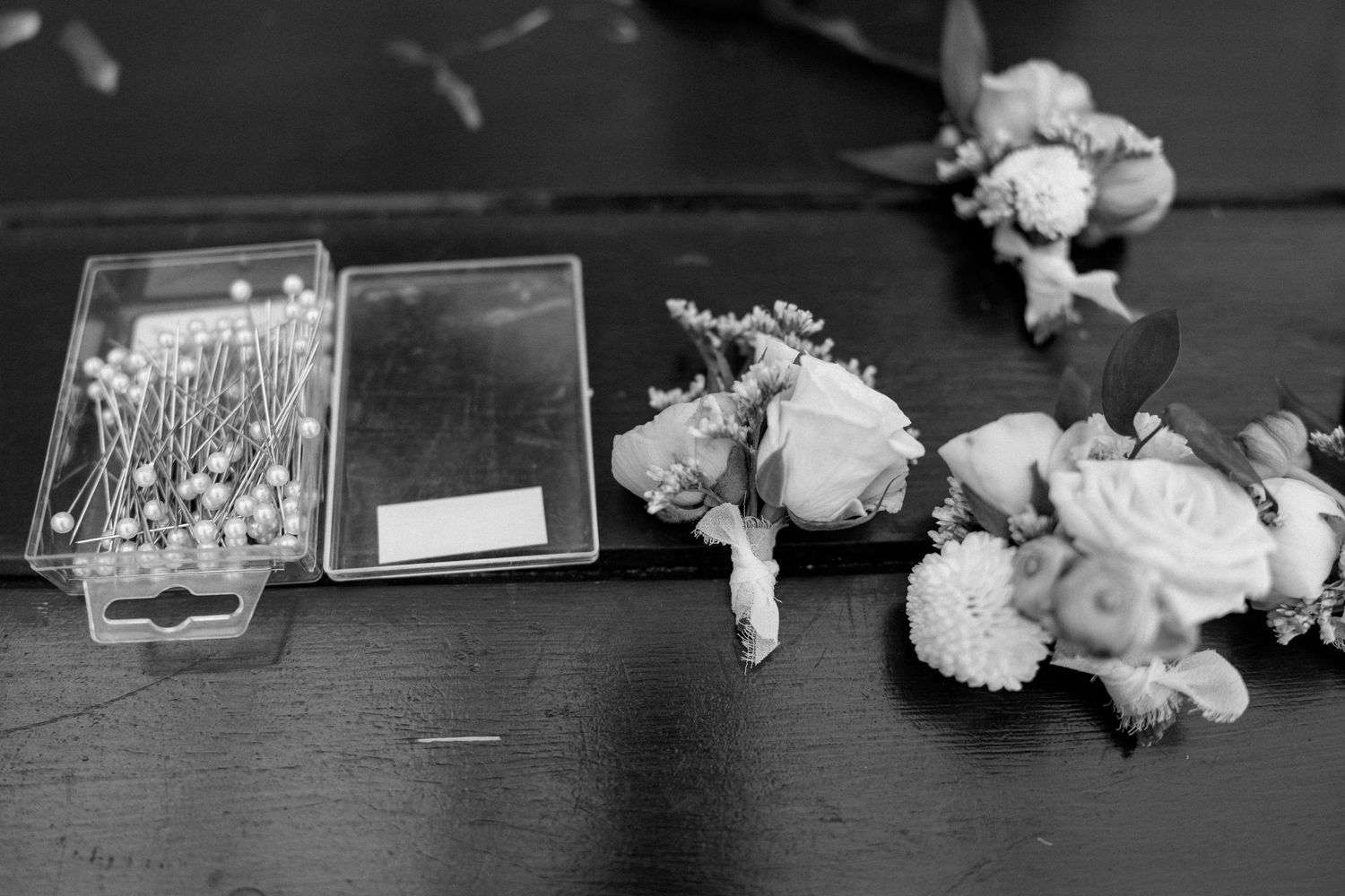 White flowers and decorative items arranged on a dark wooden surface.