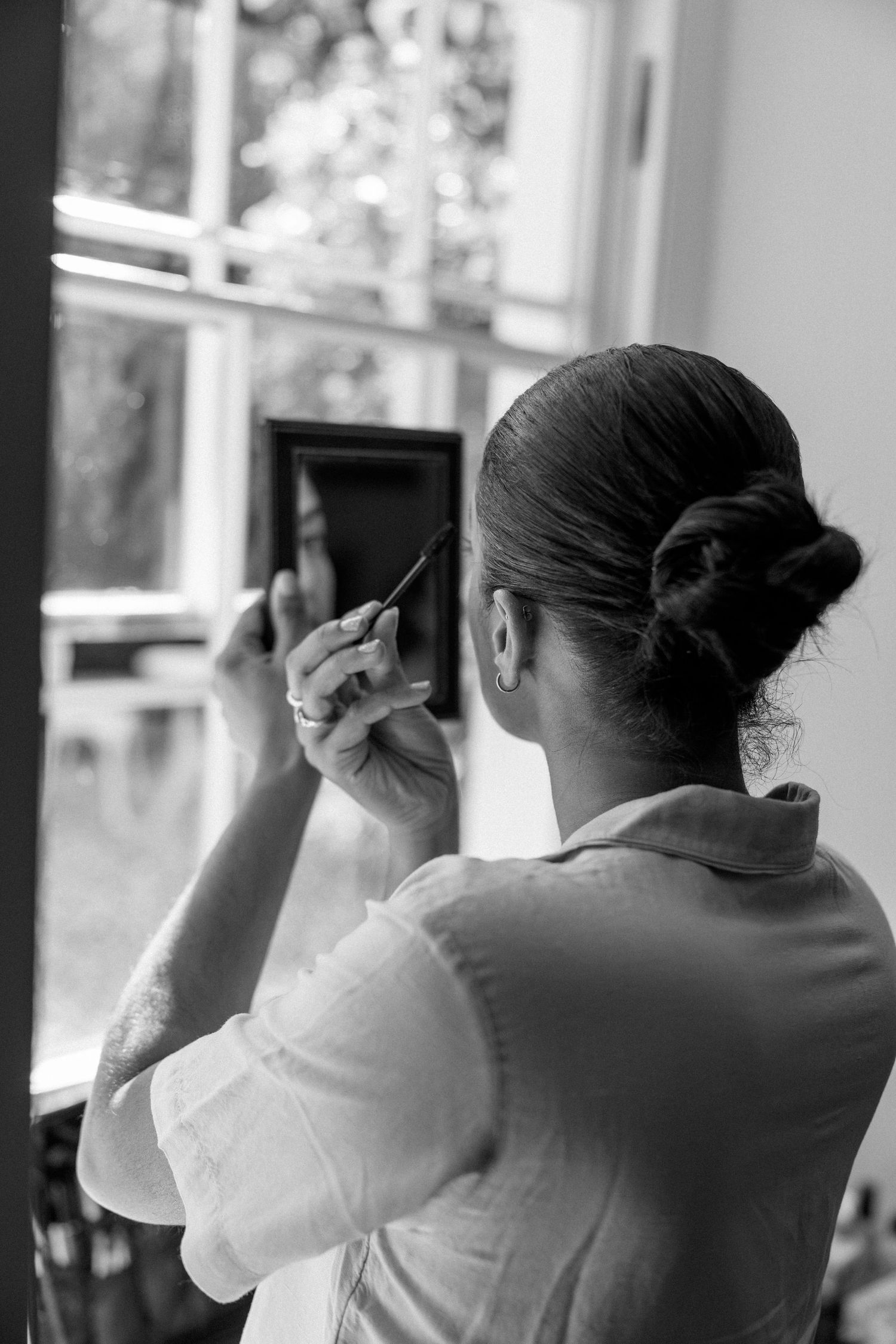 People looking out windows in black and white.