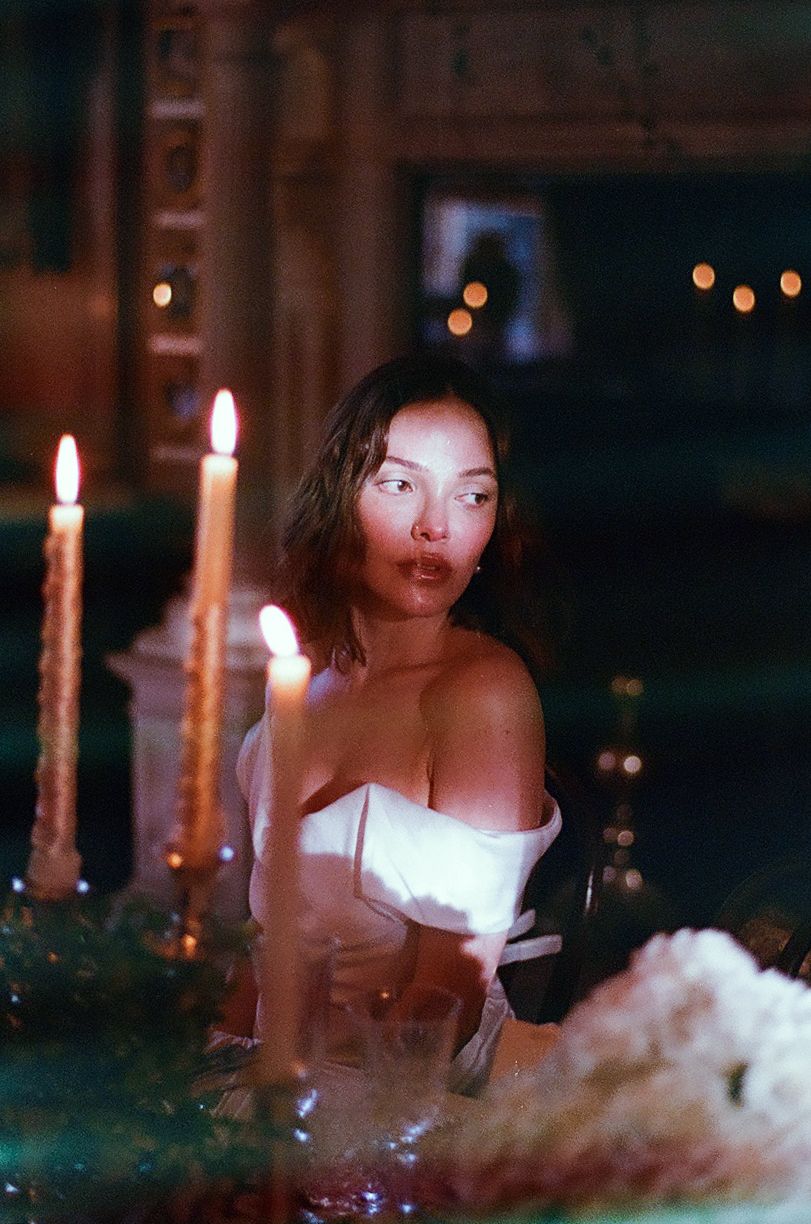 Atmospheric candlelit scene with soft lighting and glowing candles creating a romantic ambiance.