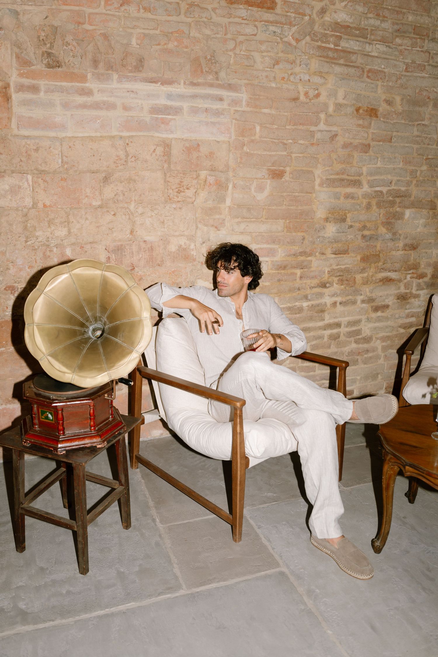 Artistic sequence showing someone falling asleep on a wooden chair with a vintage gramophone horn.