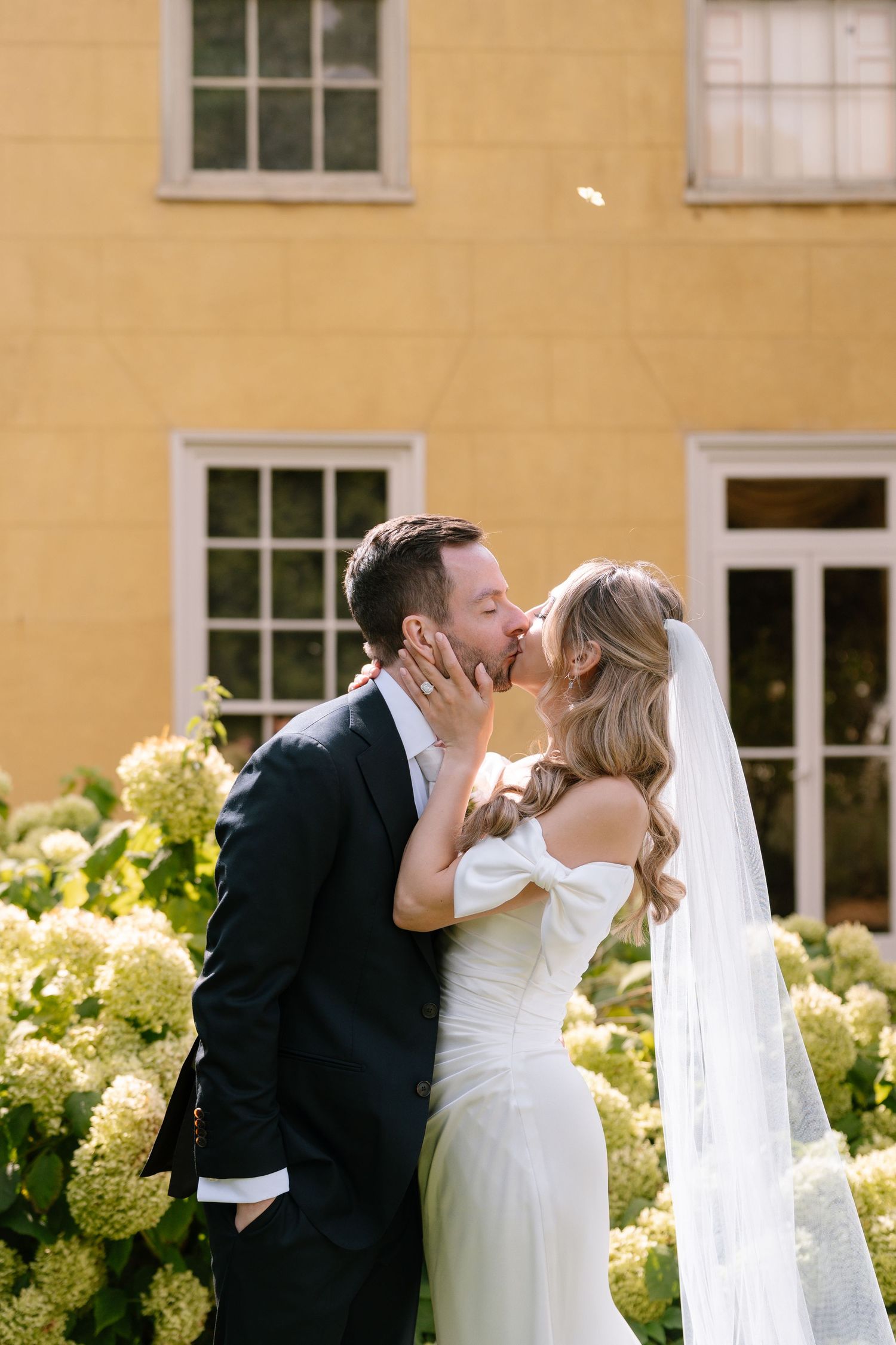 Sequence of romantic wedding photos showing the couple sharing intimate moments by blooming hydrangeas.