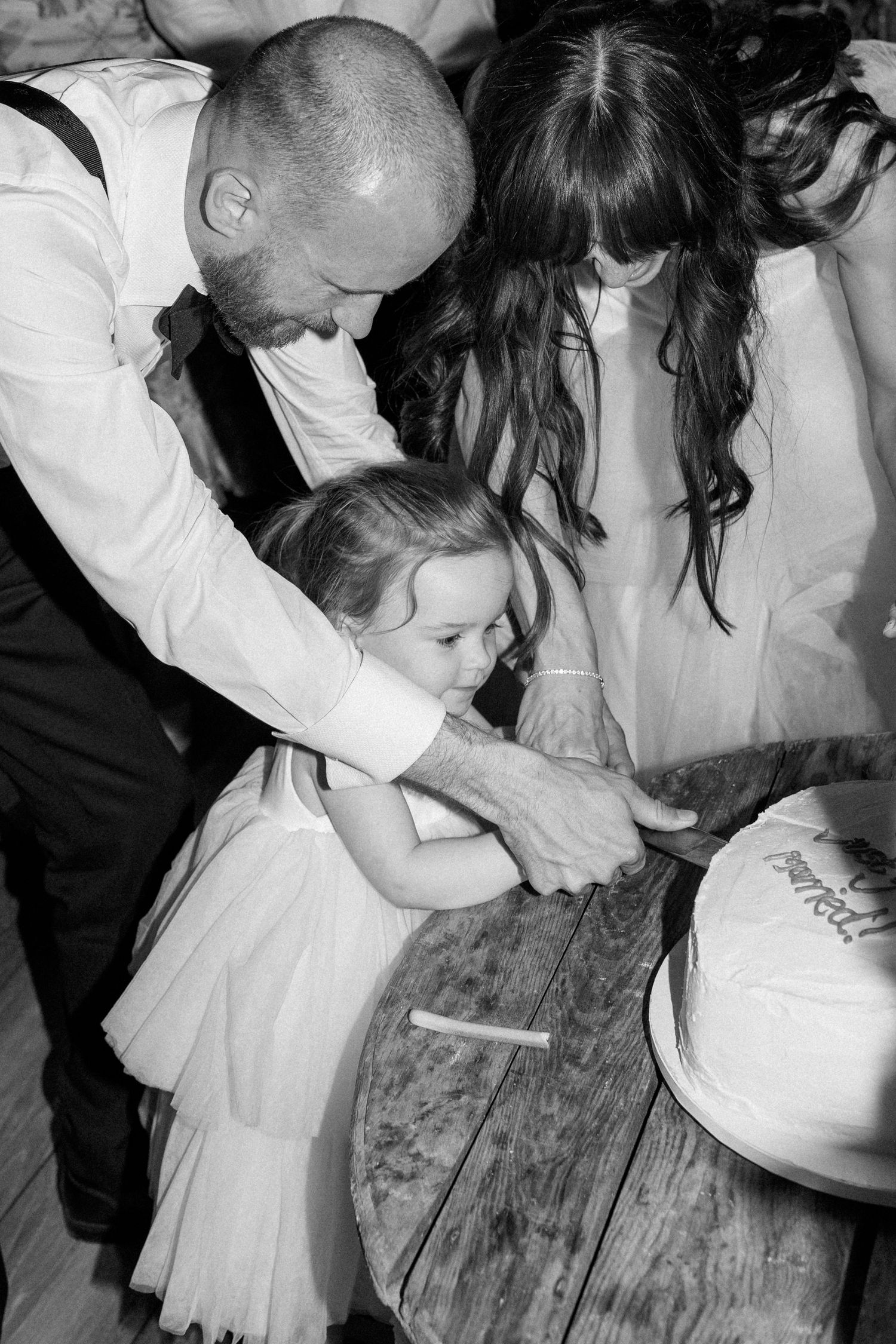 Black and white photos capture candid moments of guests dancing at a wedding reception.