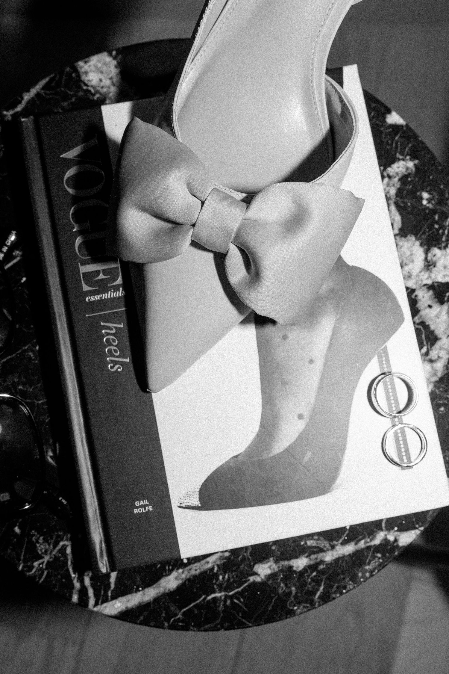 Black and white close-up of paper with decorative bow details.