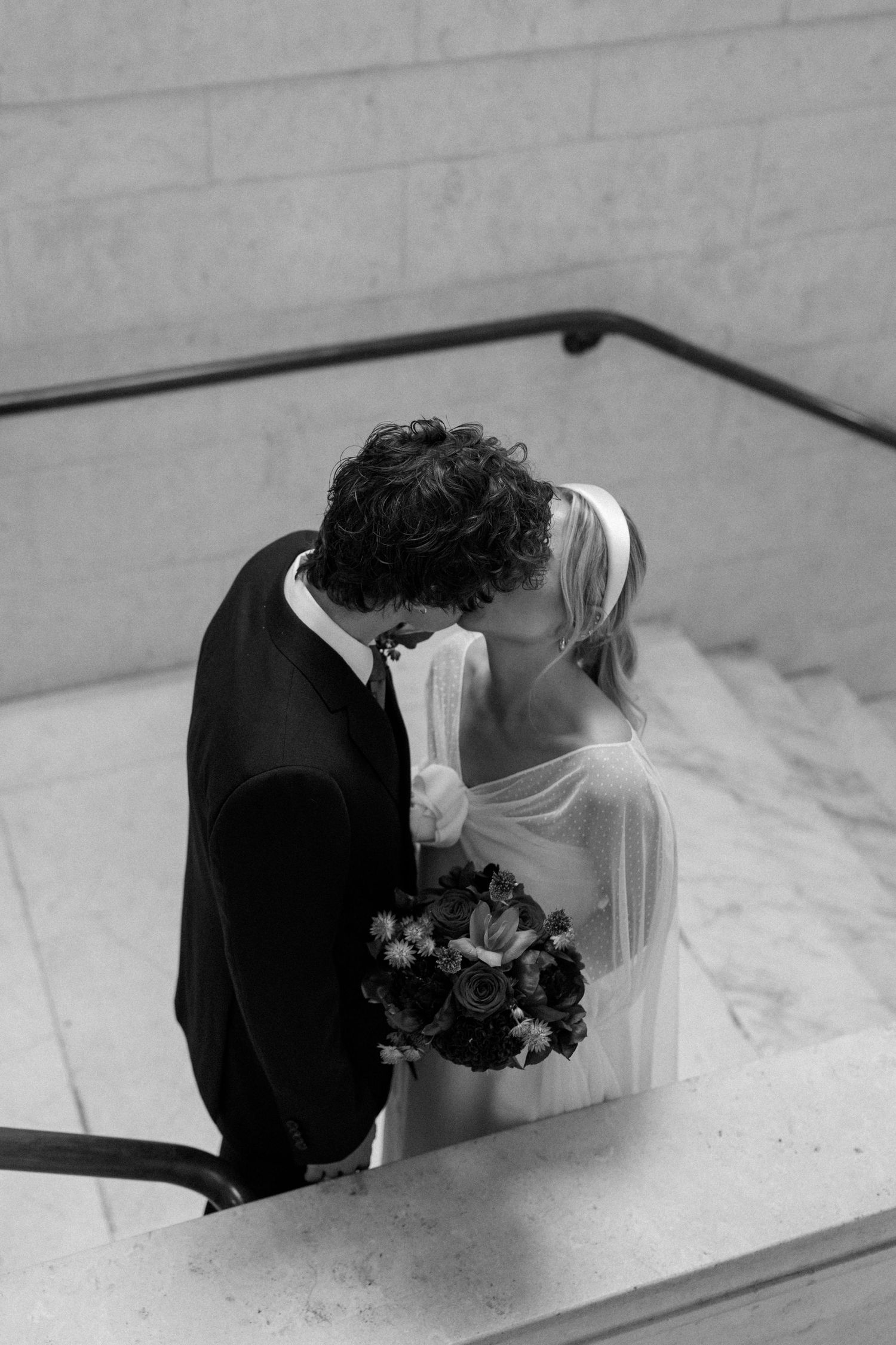 A romantic black and white photo sequence showing a bride and groom sharing an intimate kiss.