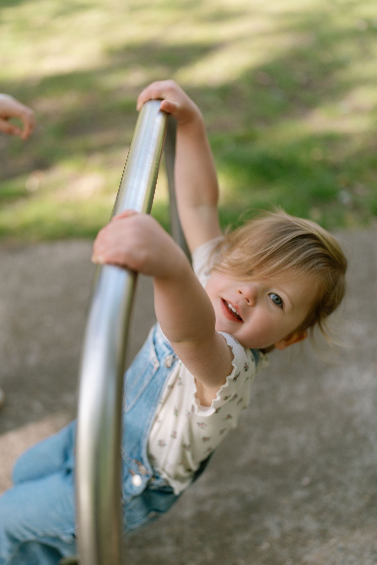 A sequence showing someone reaching for a metal bar in an outdoor setting.