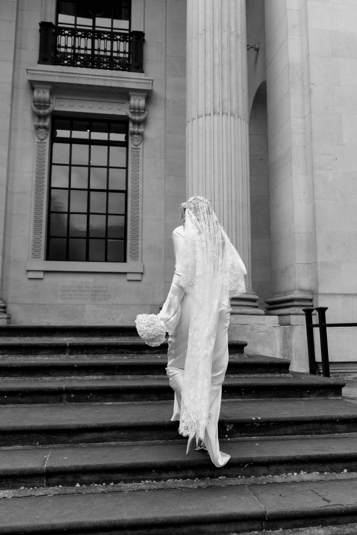 Black and white architectural photos of classical columns with wedding dress movement.