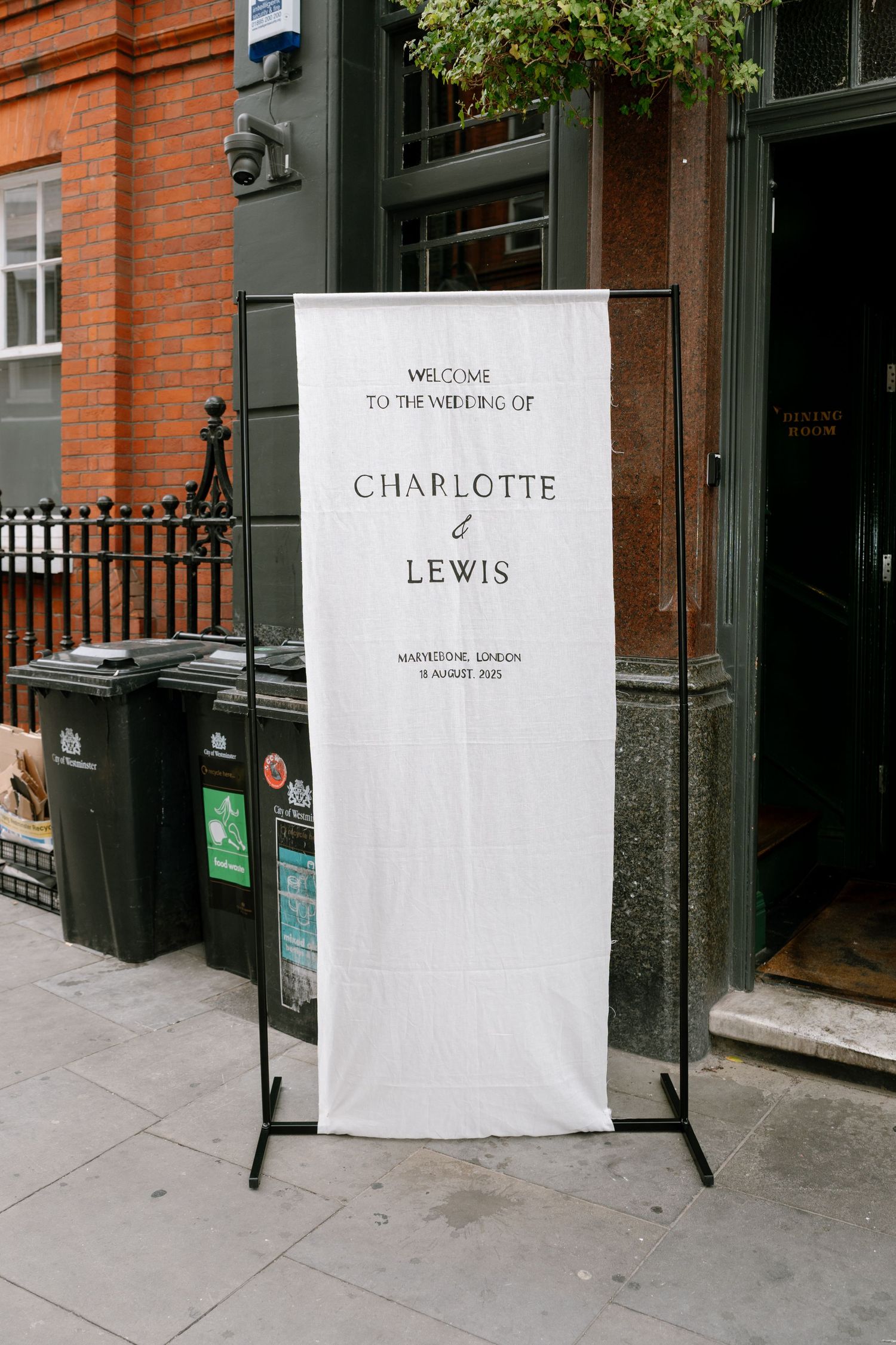 Series of minimalist storefront signs showing Charlotte & Lewis branding against brick building facade.