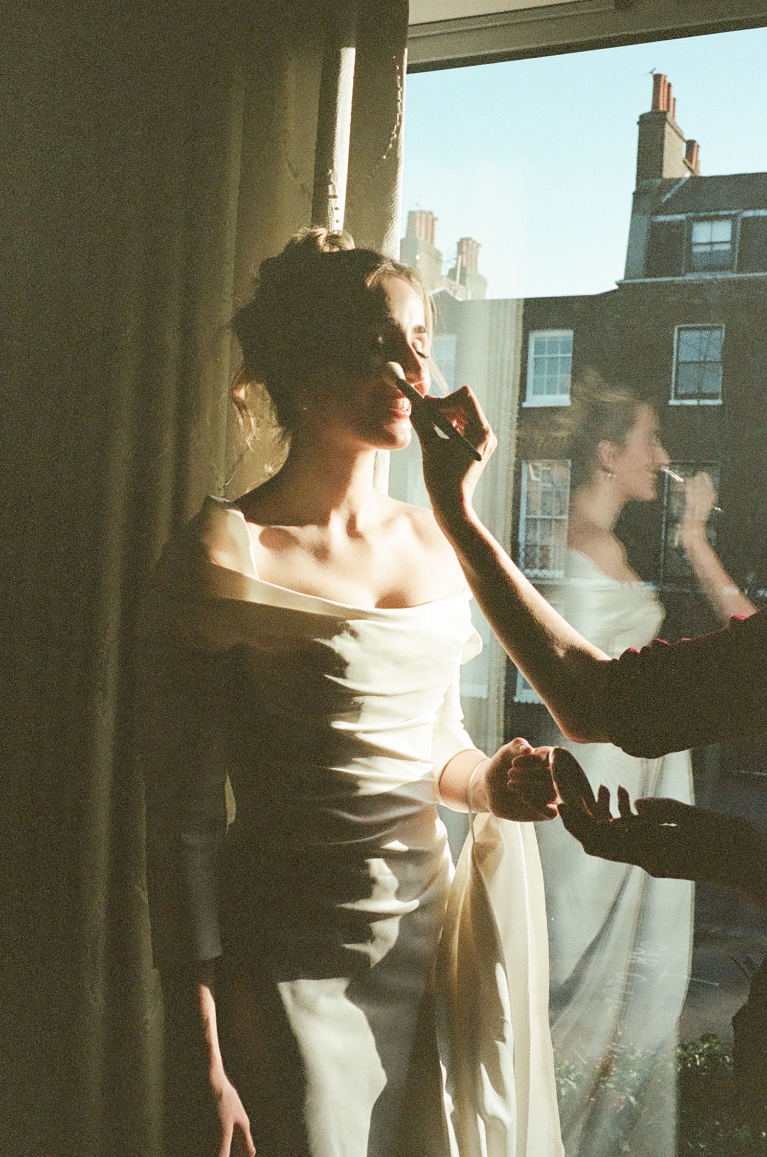 Silhouettes dancing against sunlit windows in an indoor setting.