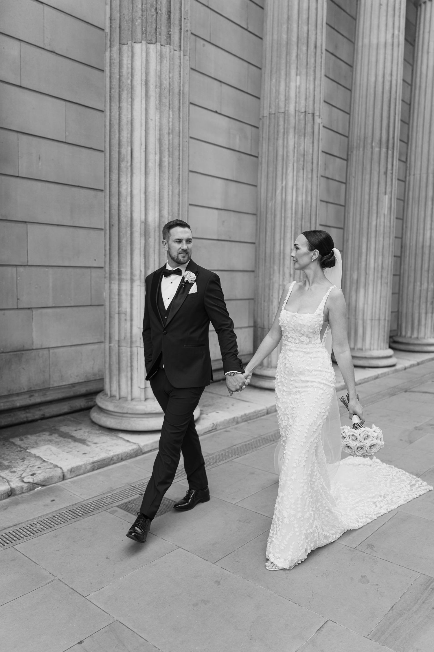Artistic wedding photo sequence showing a couple's playful interaction along a classical building wall.