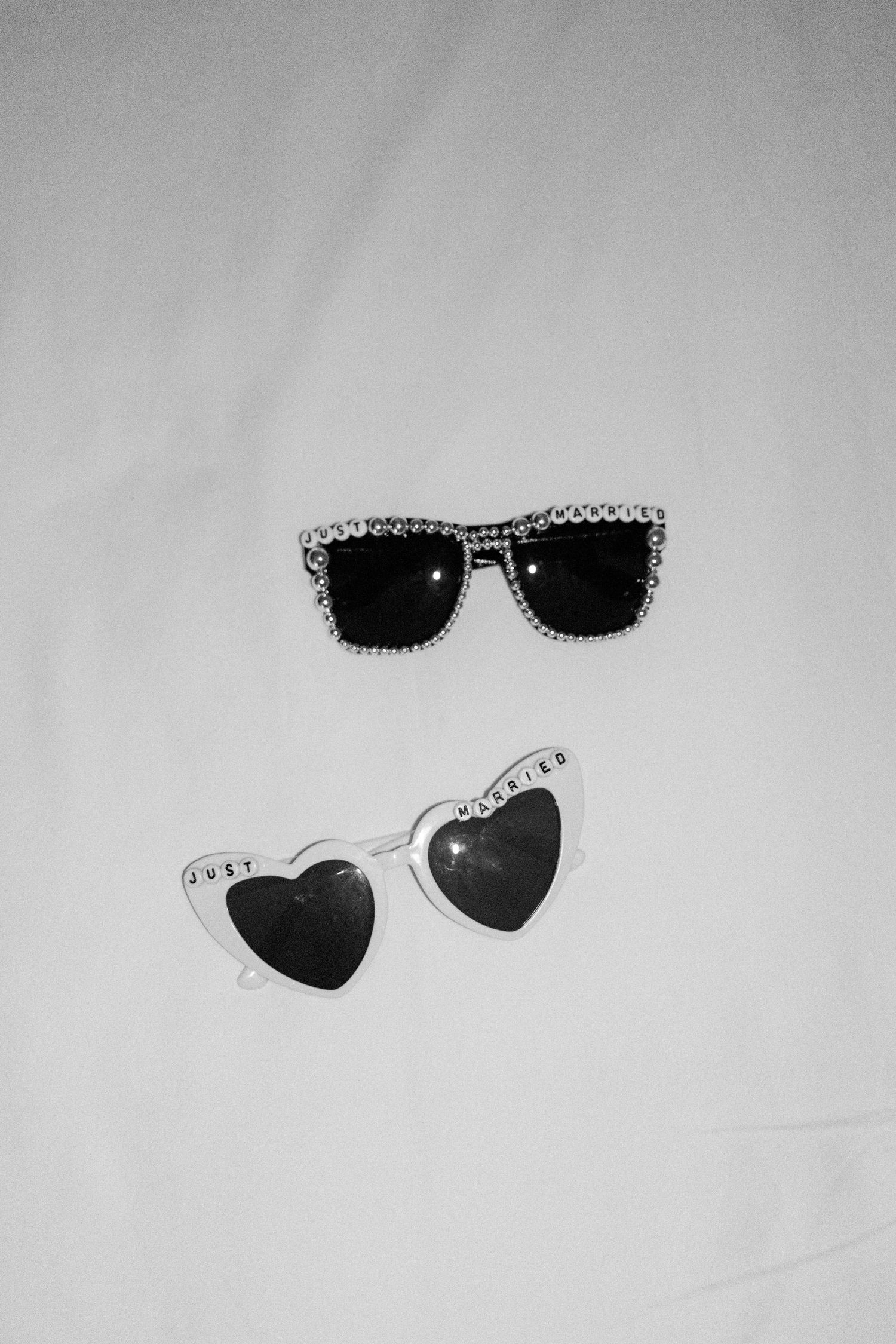 Decorative sunglasses with rhinestone details displayed on white background.