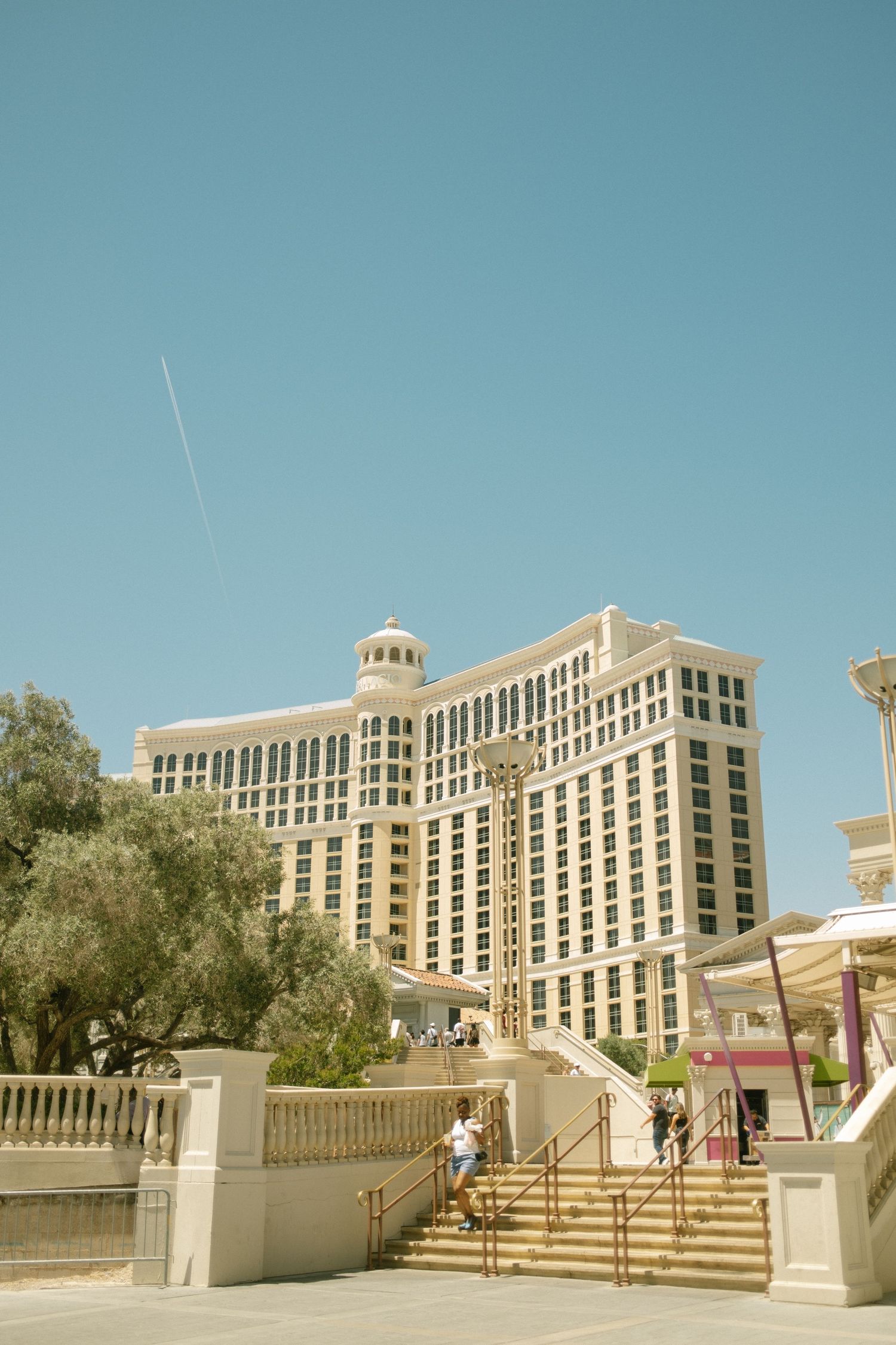Grand entrance staircase leading to Las Vegas hotel with classical architecture and columns.