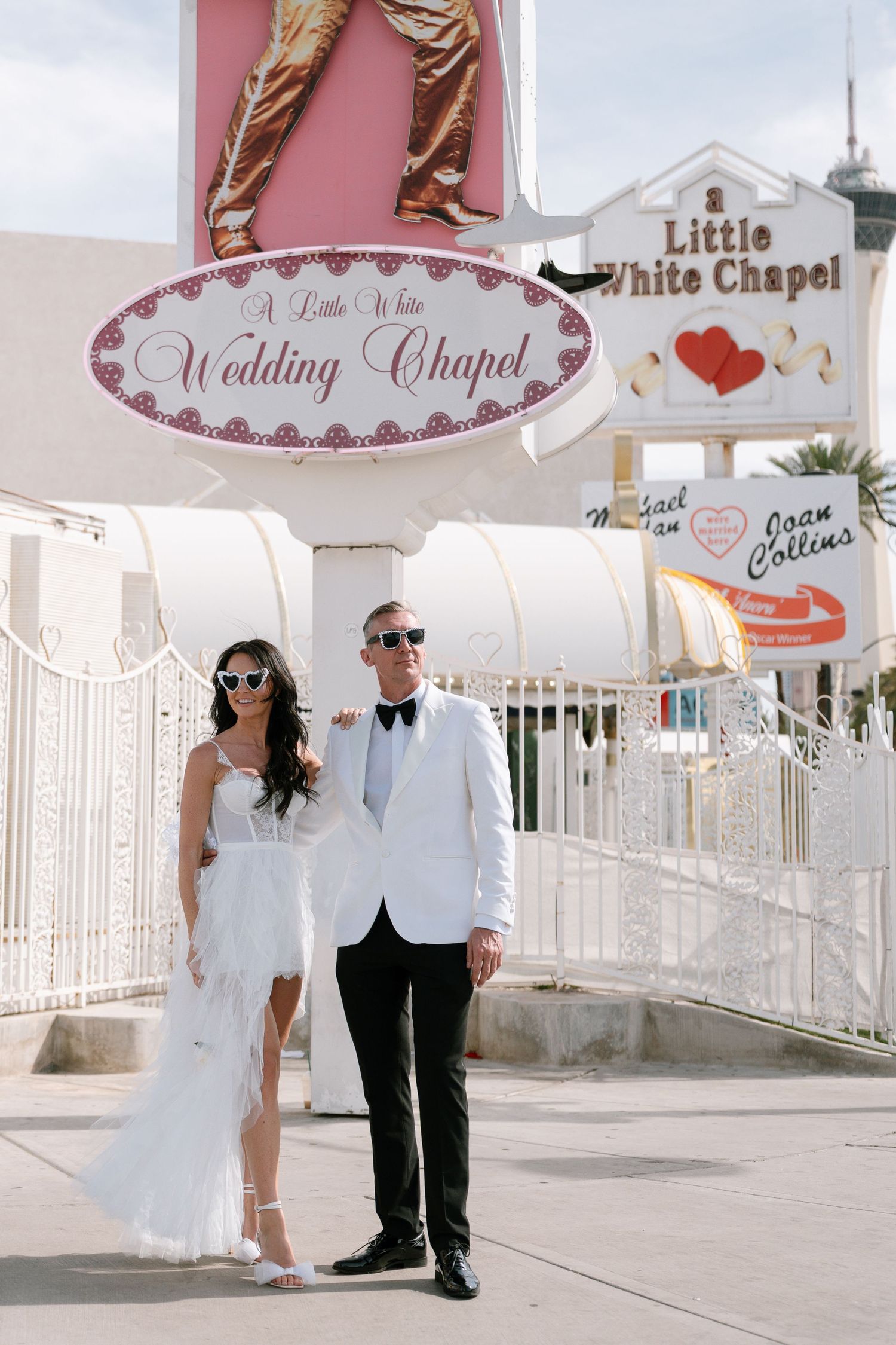 Newlyweds pose outside the Little White Wedding Chapel in Las Vegas.
