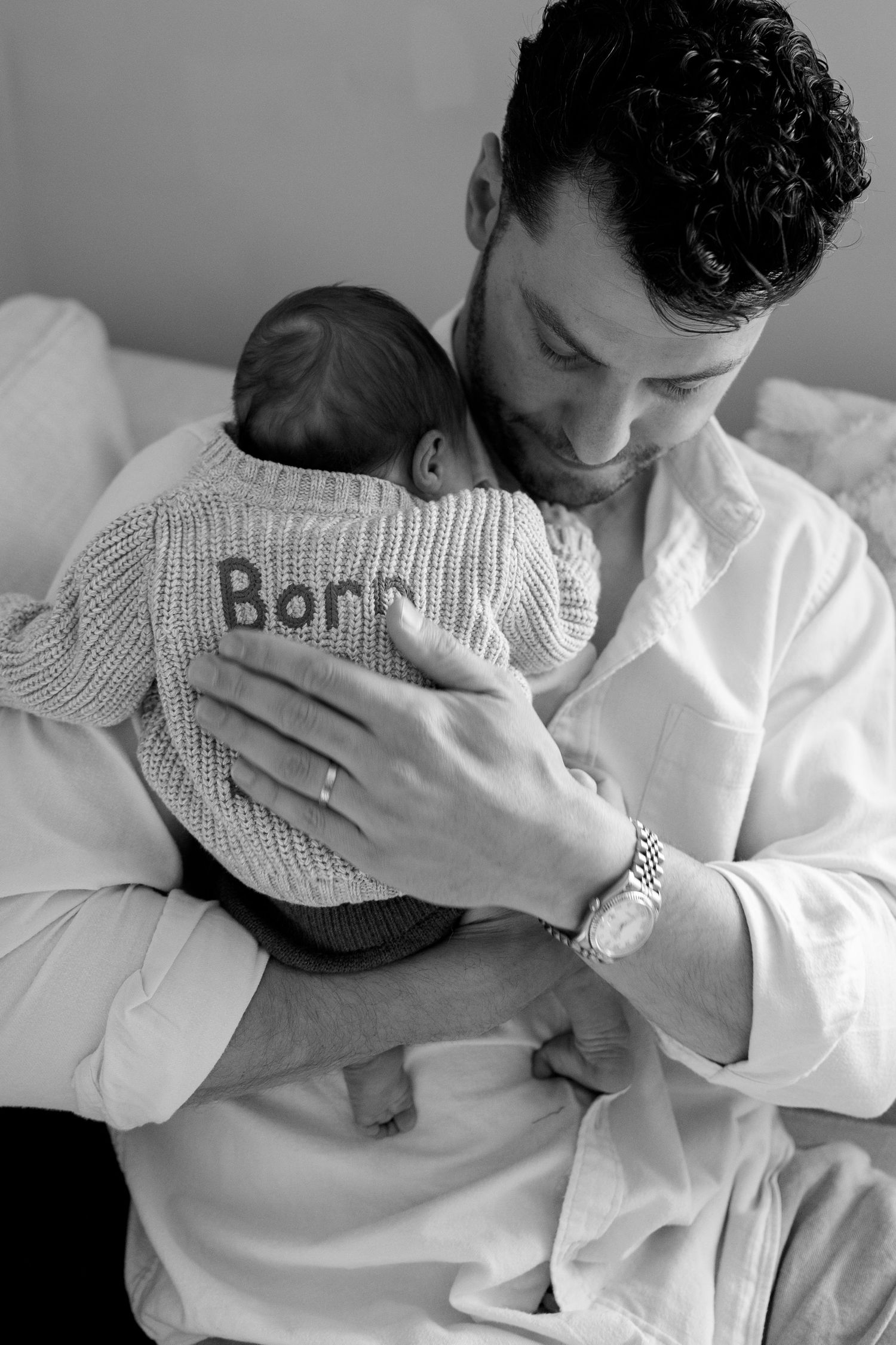 Intimate black and white photos showing tender moments with newborn baby.