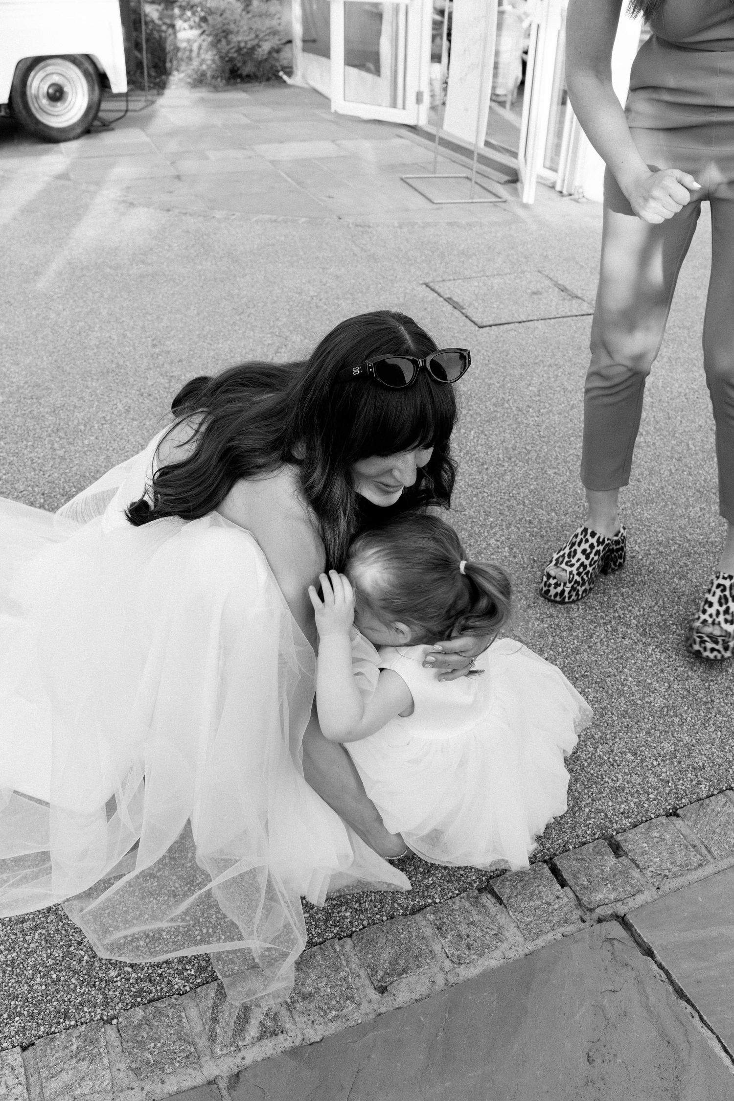 A playful moment captured in black and white on outdoor pavement.