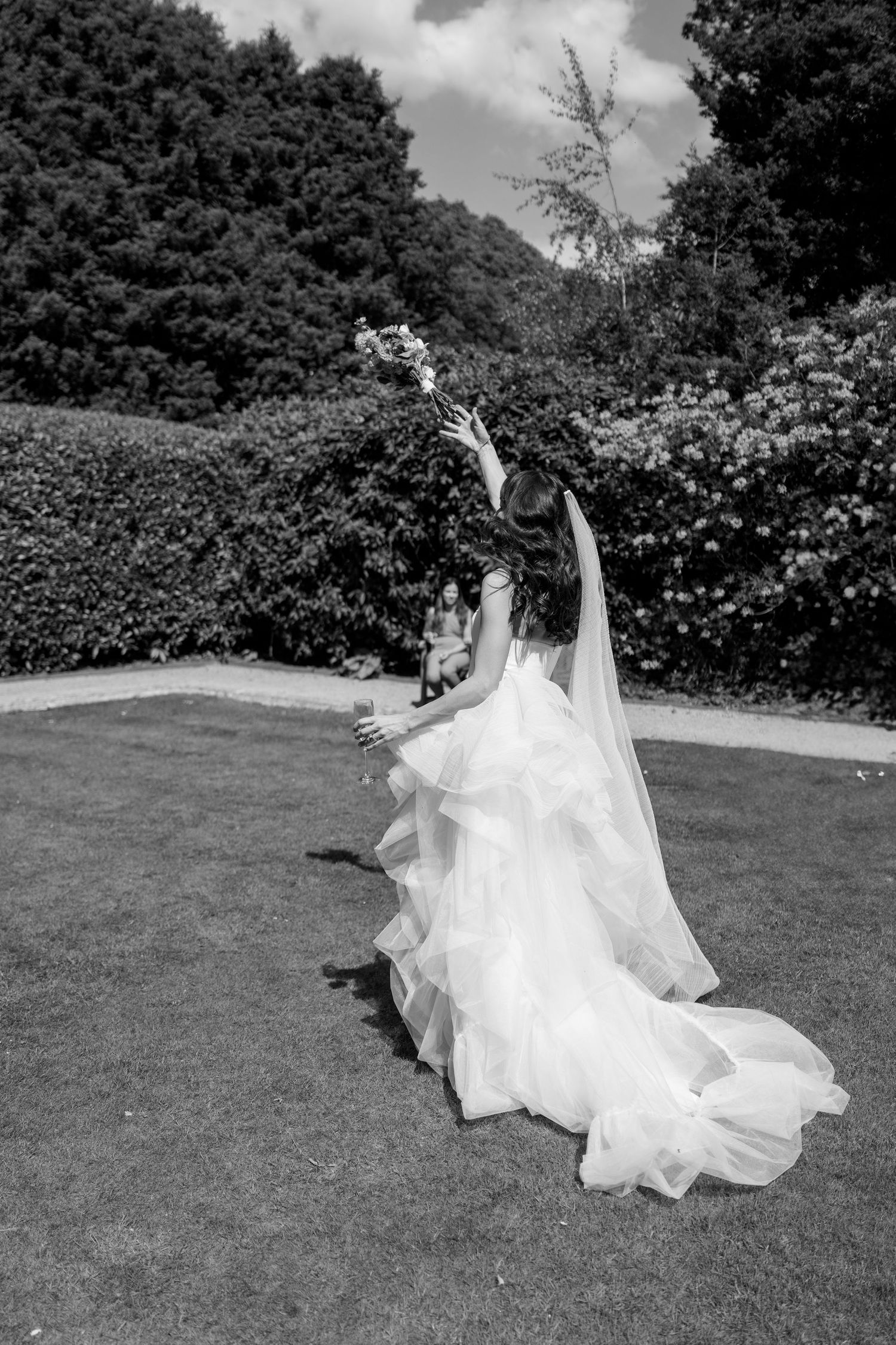 A flowing white wedding dress twirls gracefully across a green lawn in a sequence of artistic motion shots.