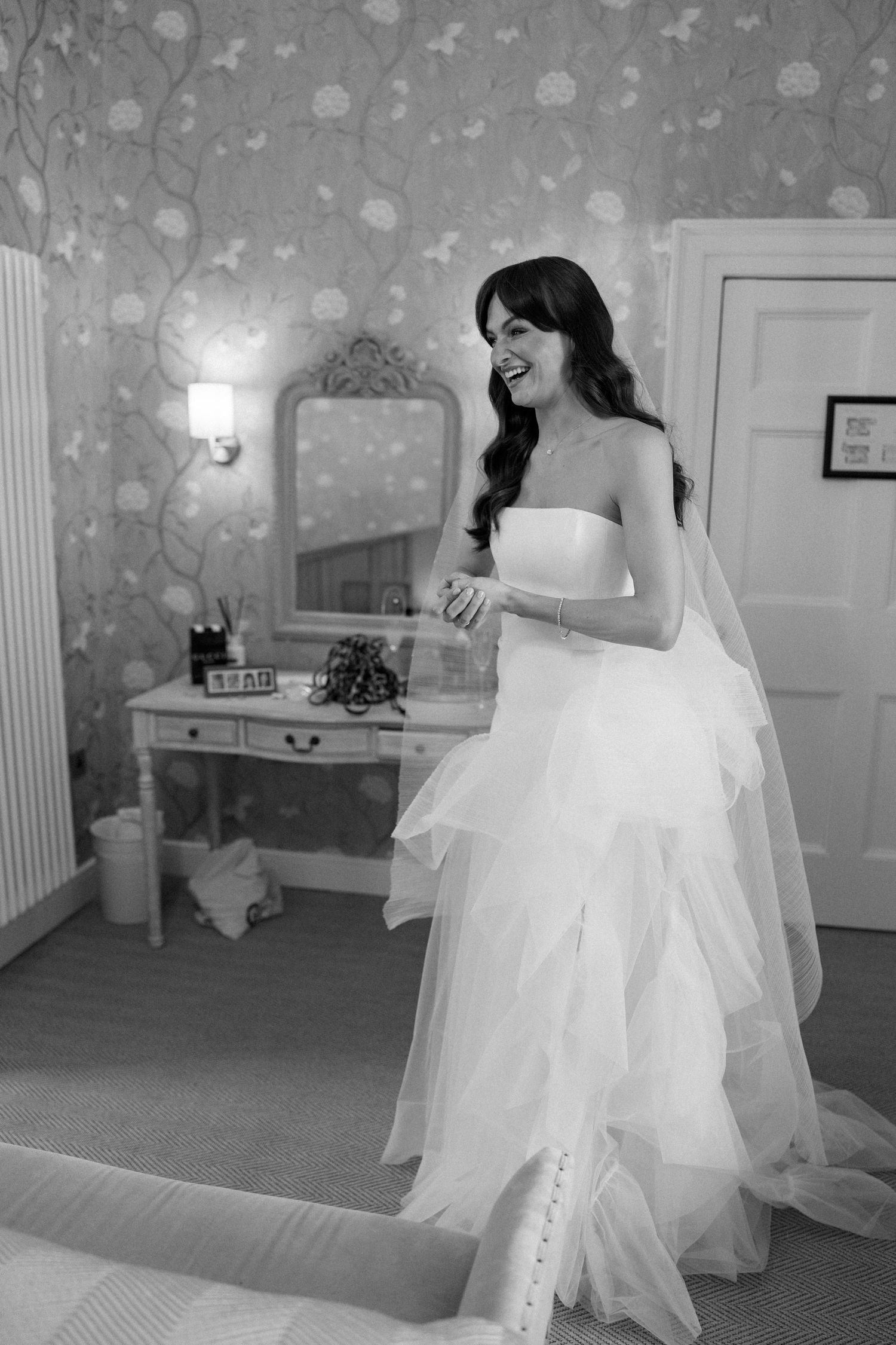 Artistic sequence showing flowing white dress movements against floral wallpaper.