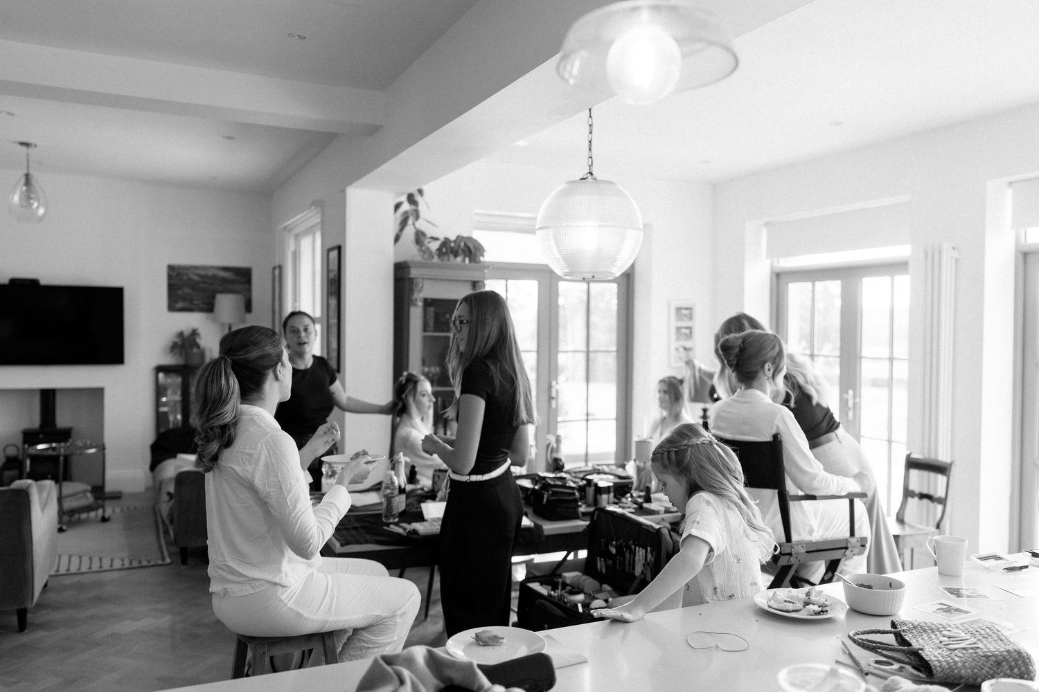 Panoramic view of beauty preparation session in bright modern interior with multiple stylists working.
