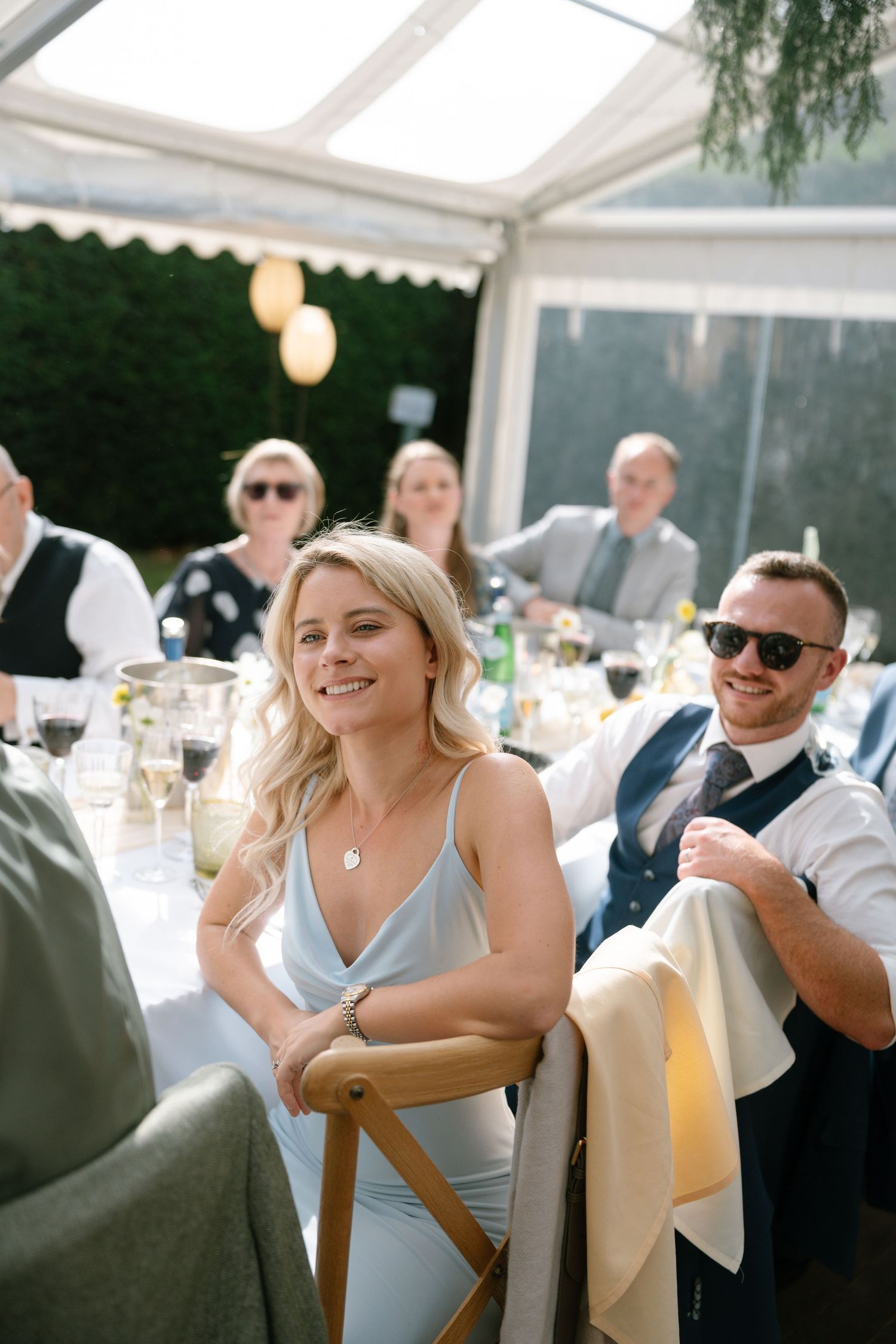 Candid moments of guests enjoying themselves at an elegant outdoor reception.