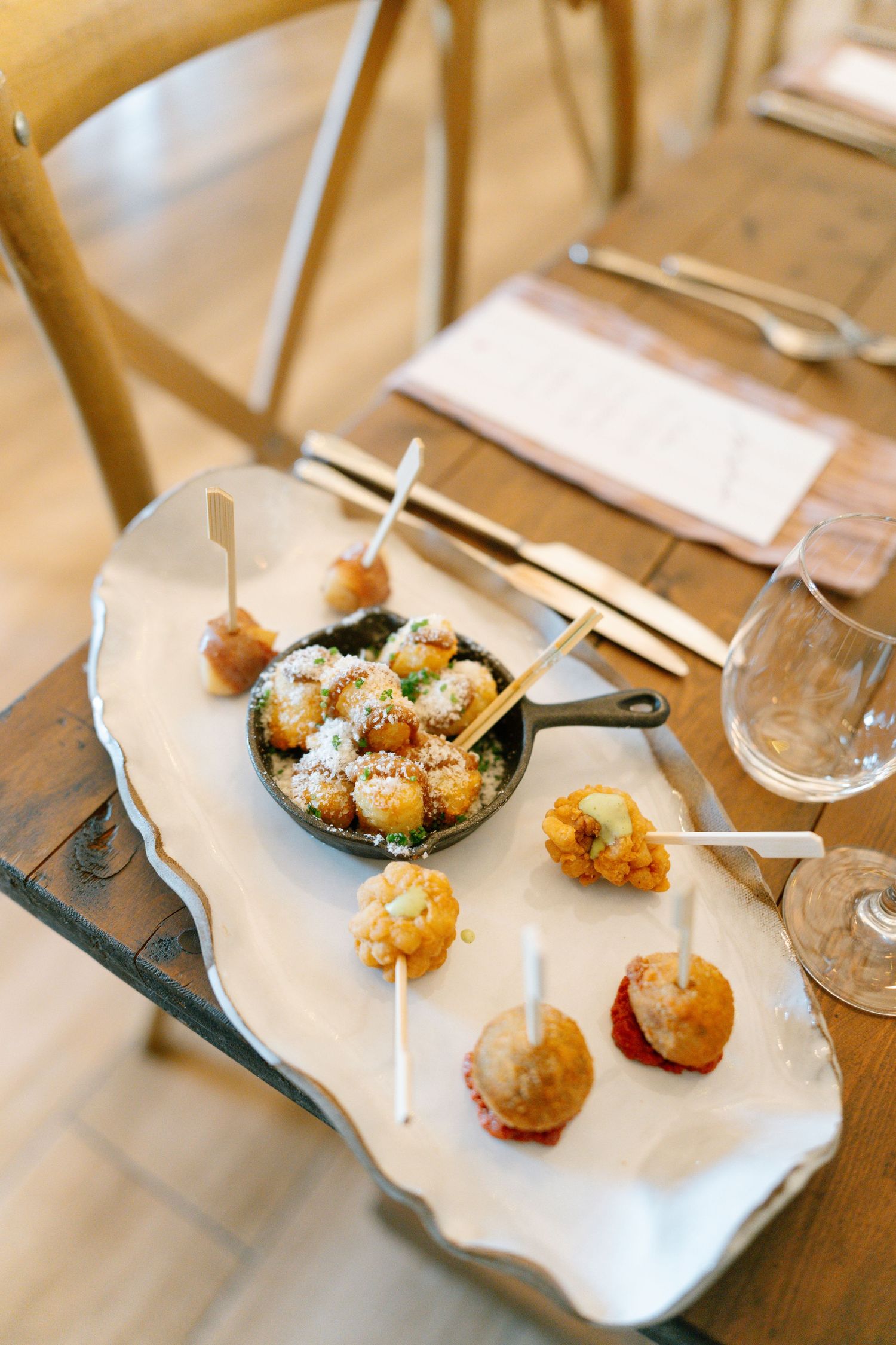 Gourmet appetizers and hors d'oeuvres served on elegant white platter.