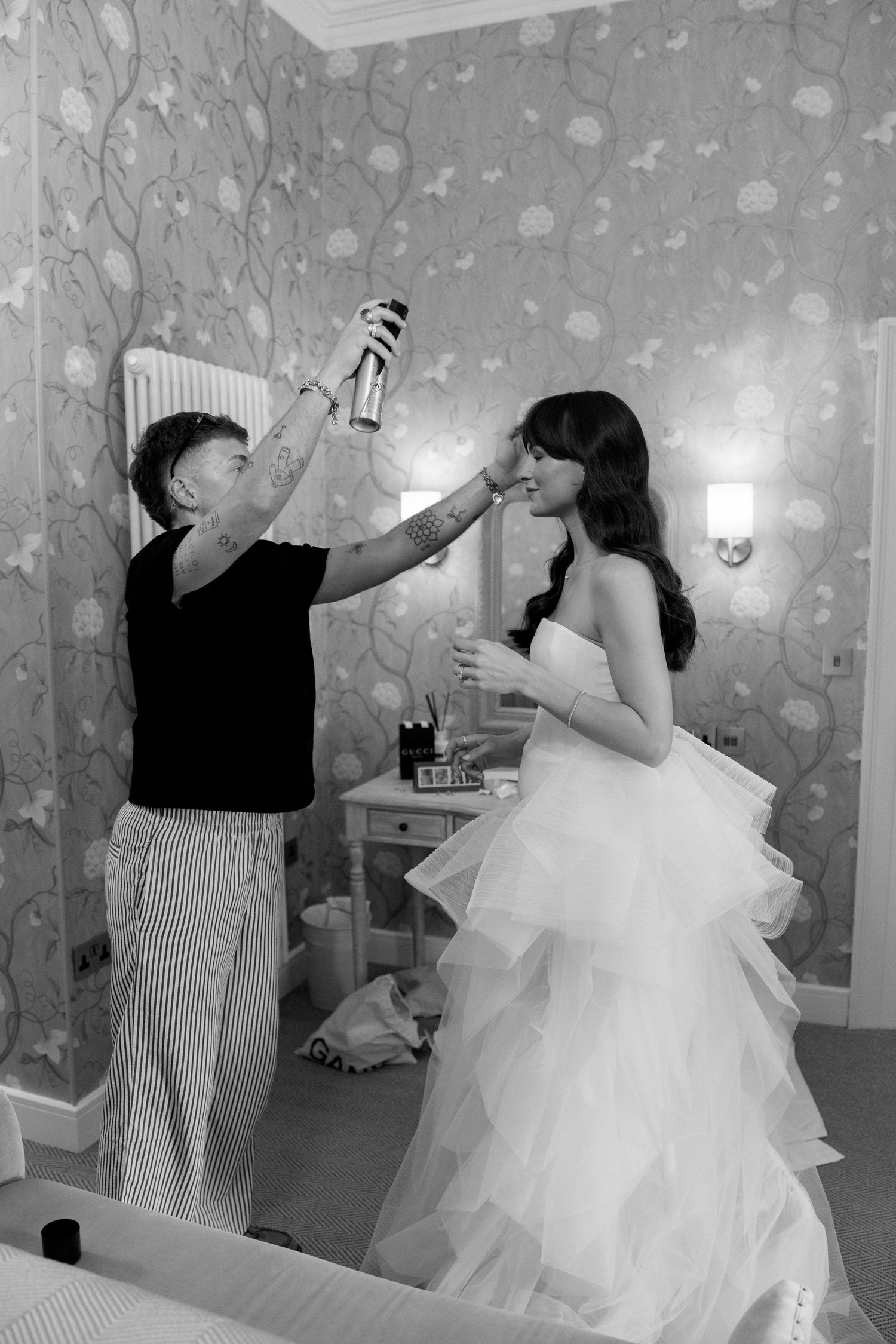 Black and white sequence capturing dancing and twirling movements in an elegantly decorated room.