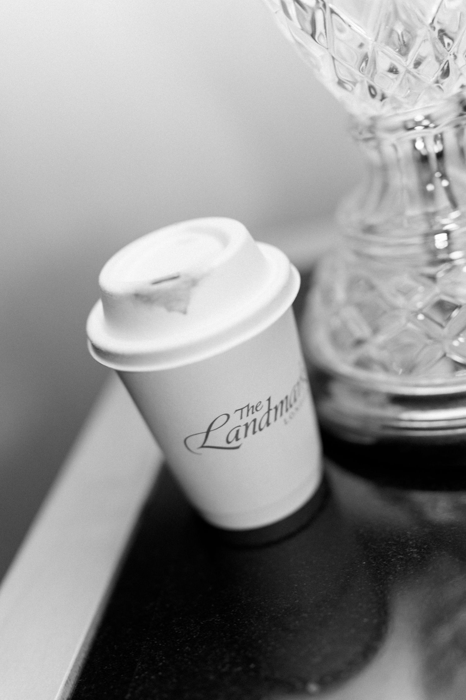 Artistic close-up shots of white ceramic cups with text against dark background.