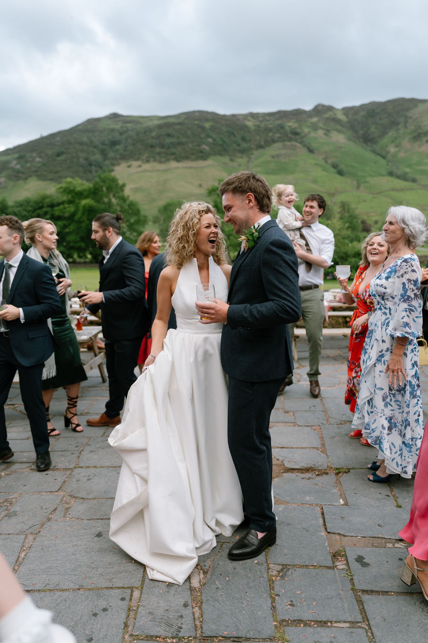 Wedding celebration on a stone patio with mountains in the background.