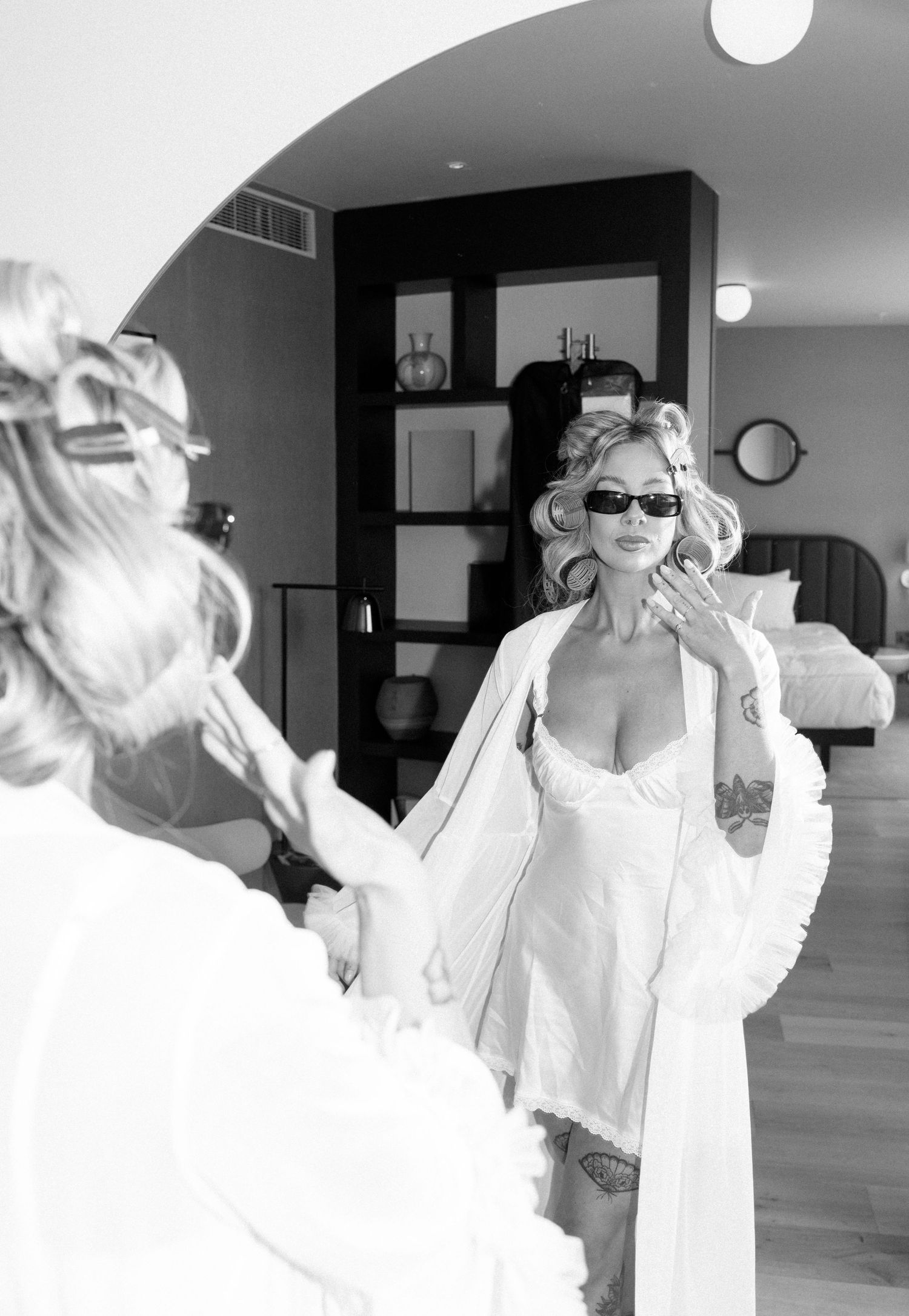 Black and white photo sequence showing playful moments in a white dress and sunglasses.