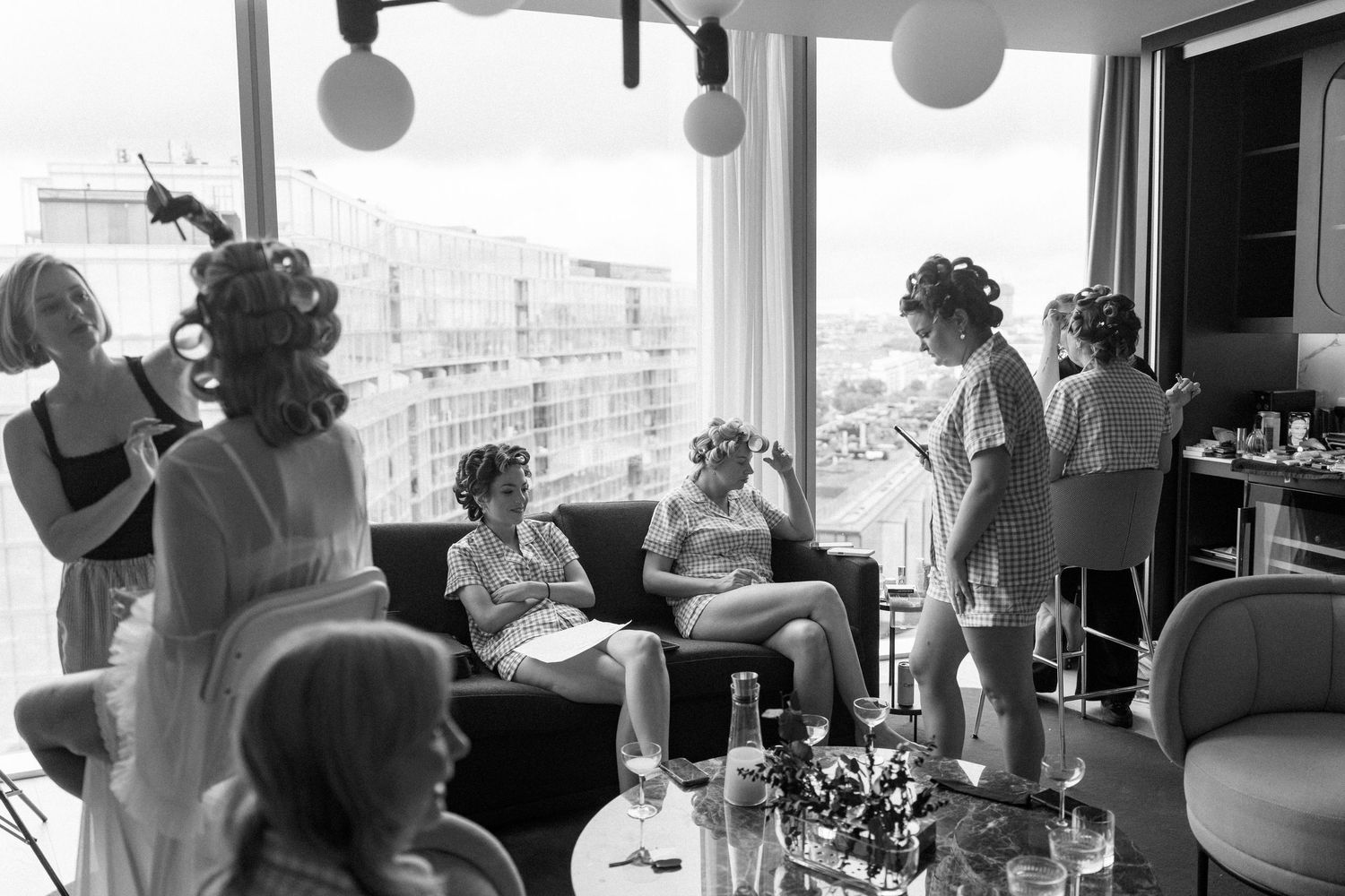 A group of people gather at a rooftop restaurant with city views in this vintage black and white photograph.
