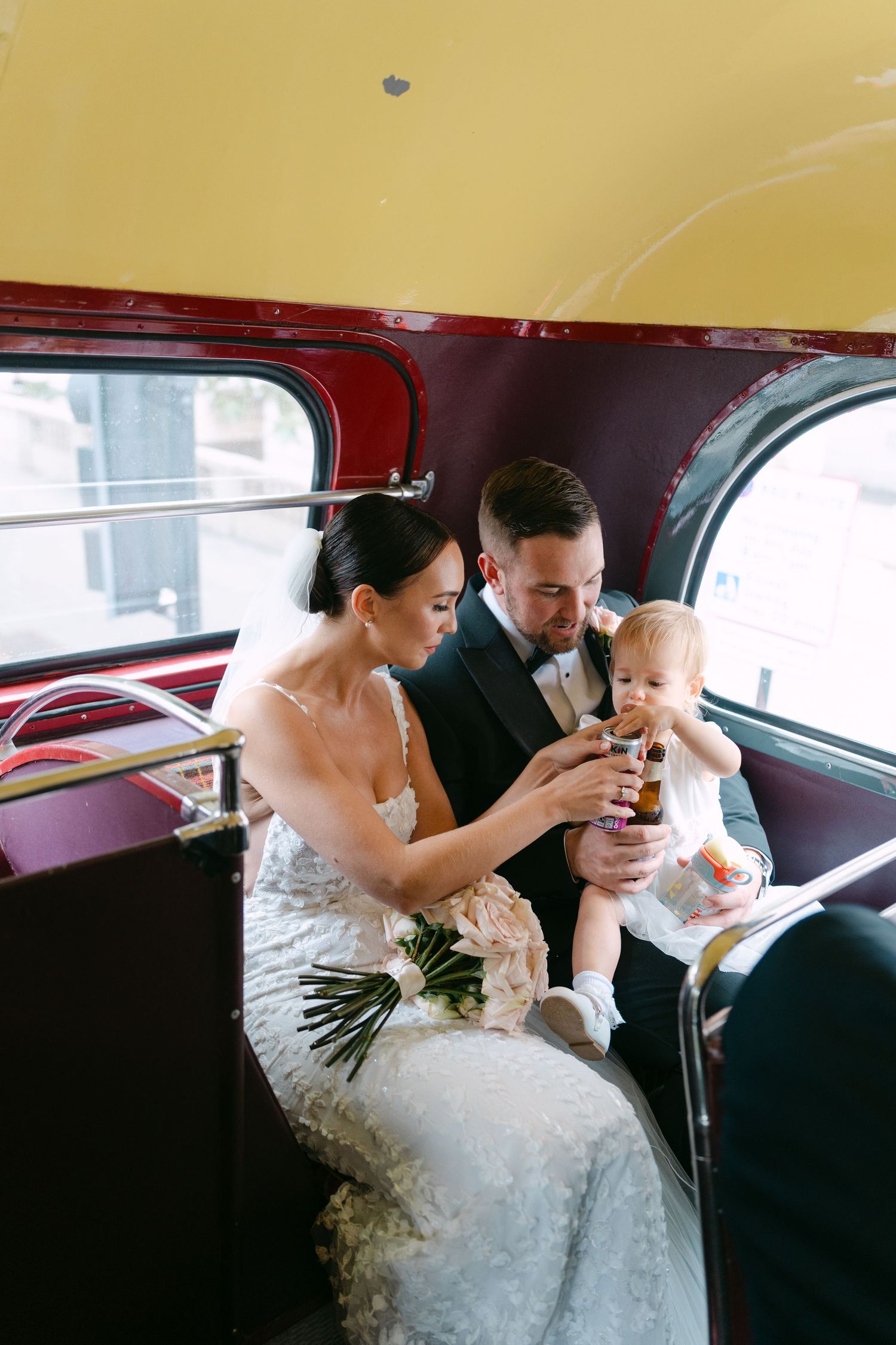 Intimate wedding celebration moment inside a classic red London bus.