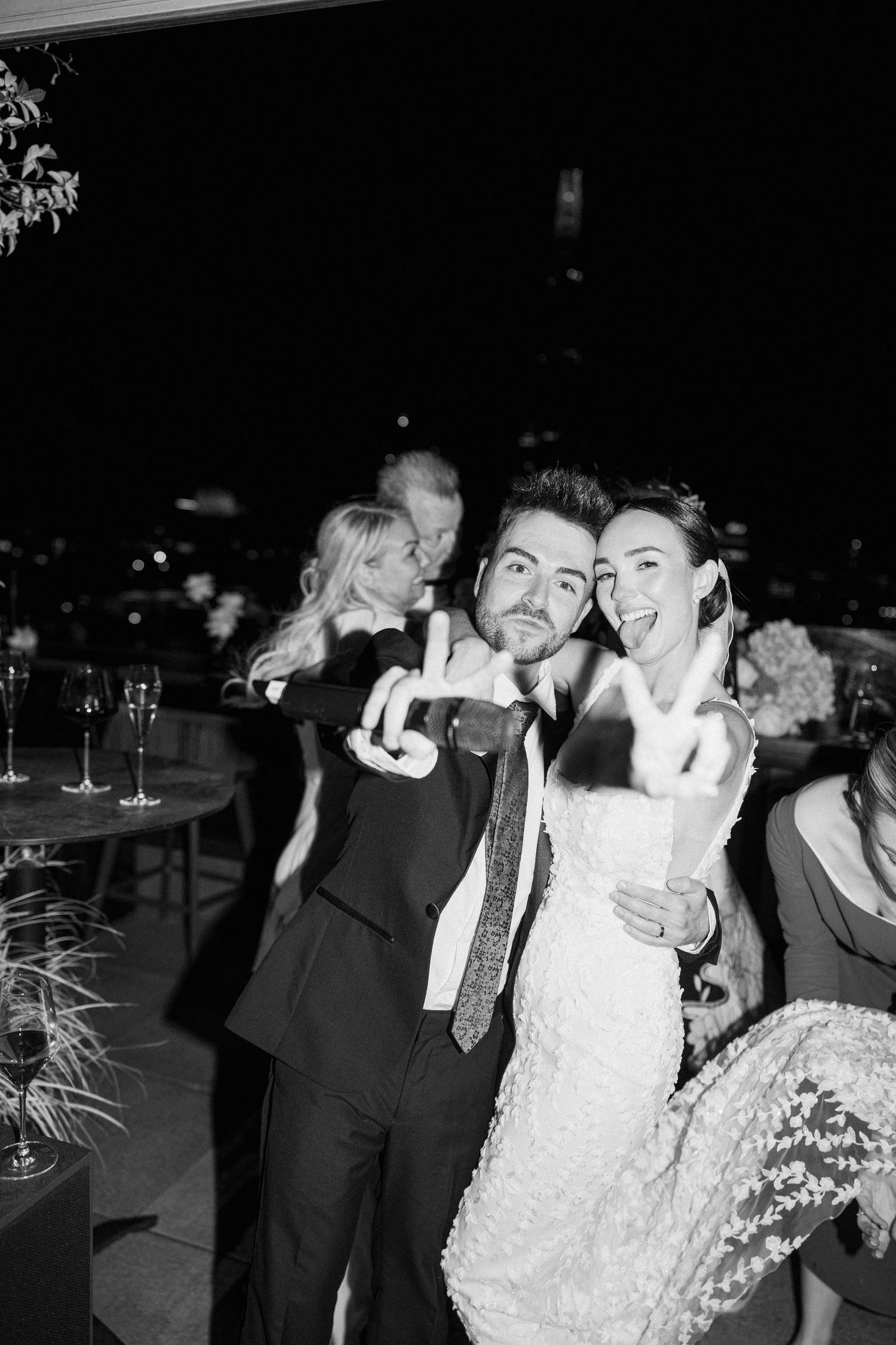 Wedding celebration with guests enjoying a festive moment at a nighttime reception.