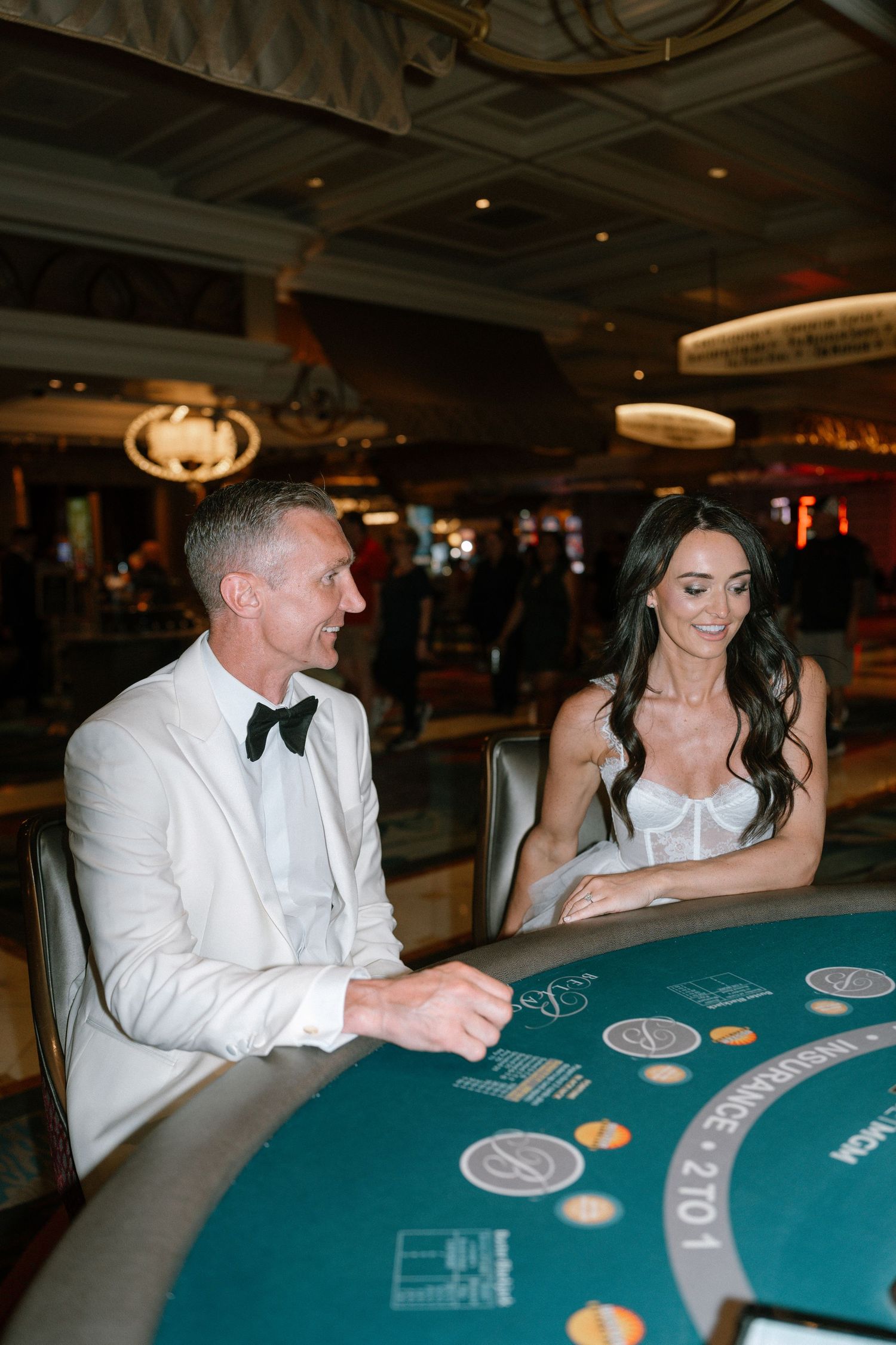 Bride and groom enjoying a game of blackjack at a Las Vegas casino table.
