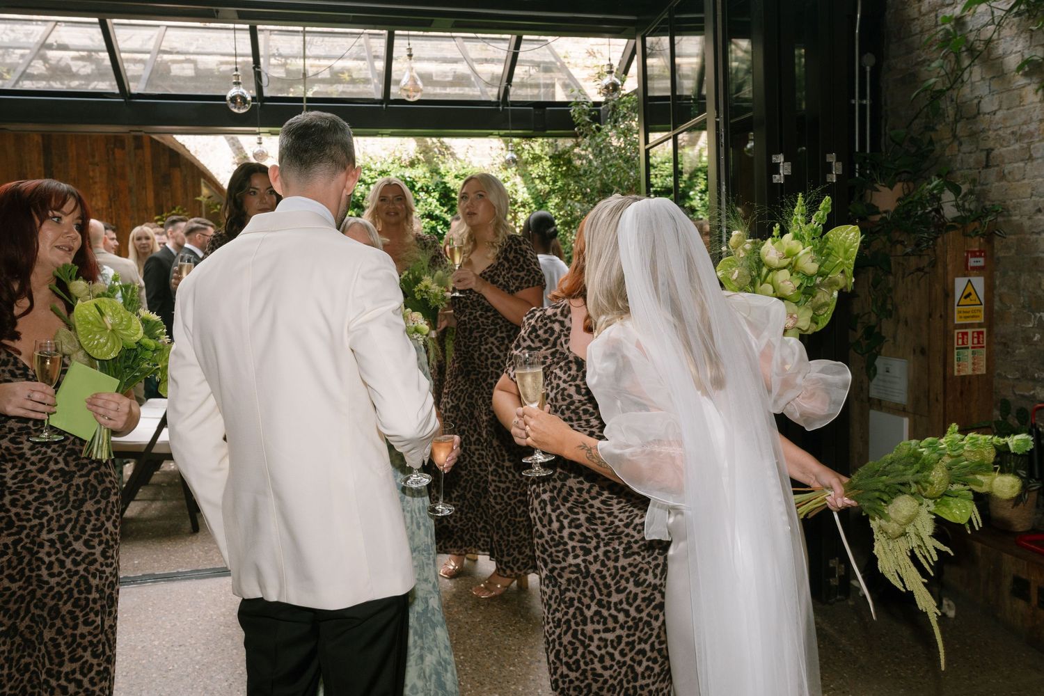 Wedding reception dance floor with guests celebrating in formal attire.