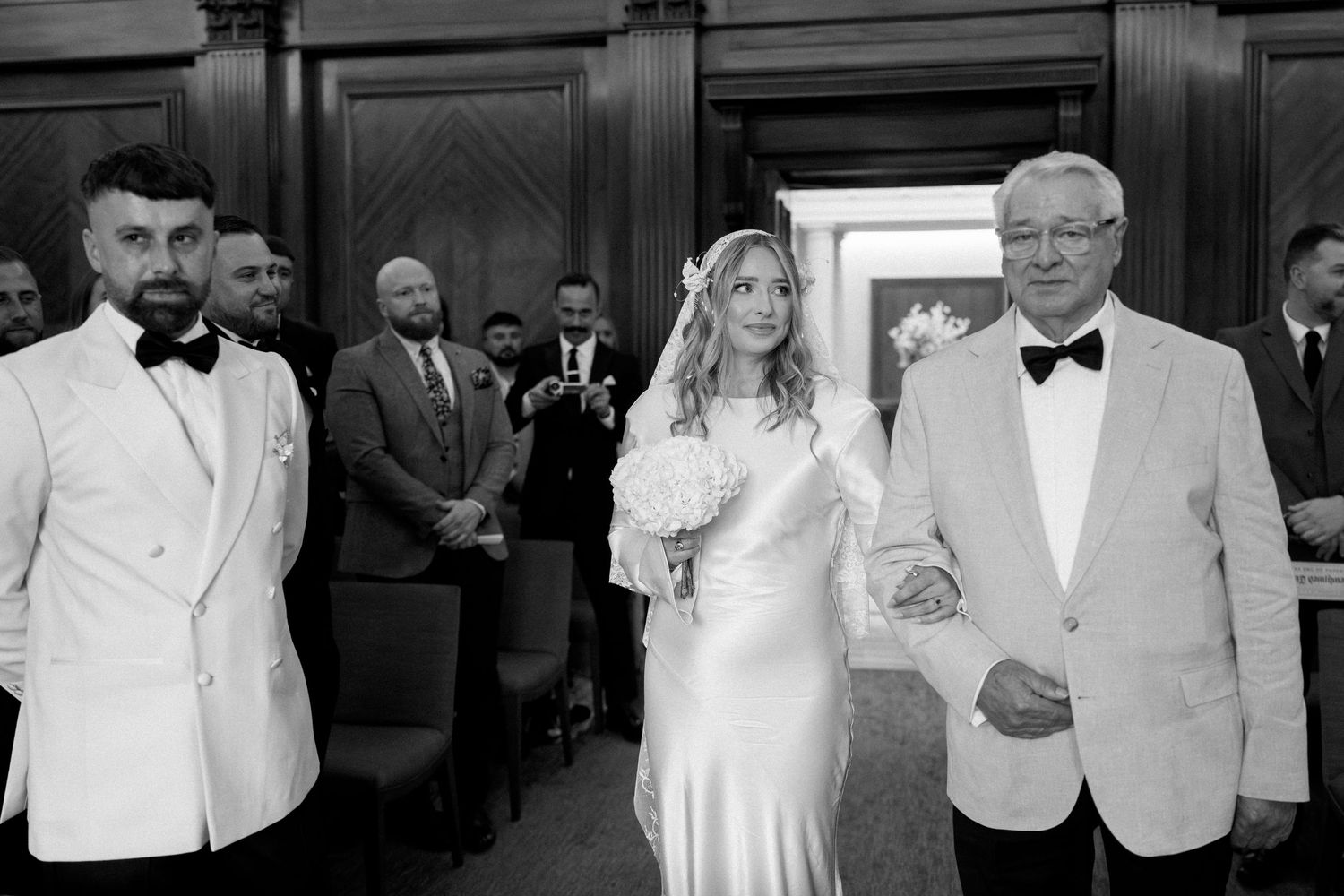 A series of black and white photographs showing people in formal attire at what appears to be a gala or formal event.
