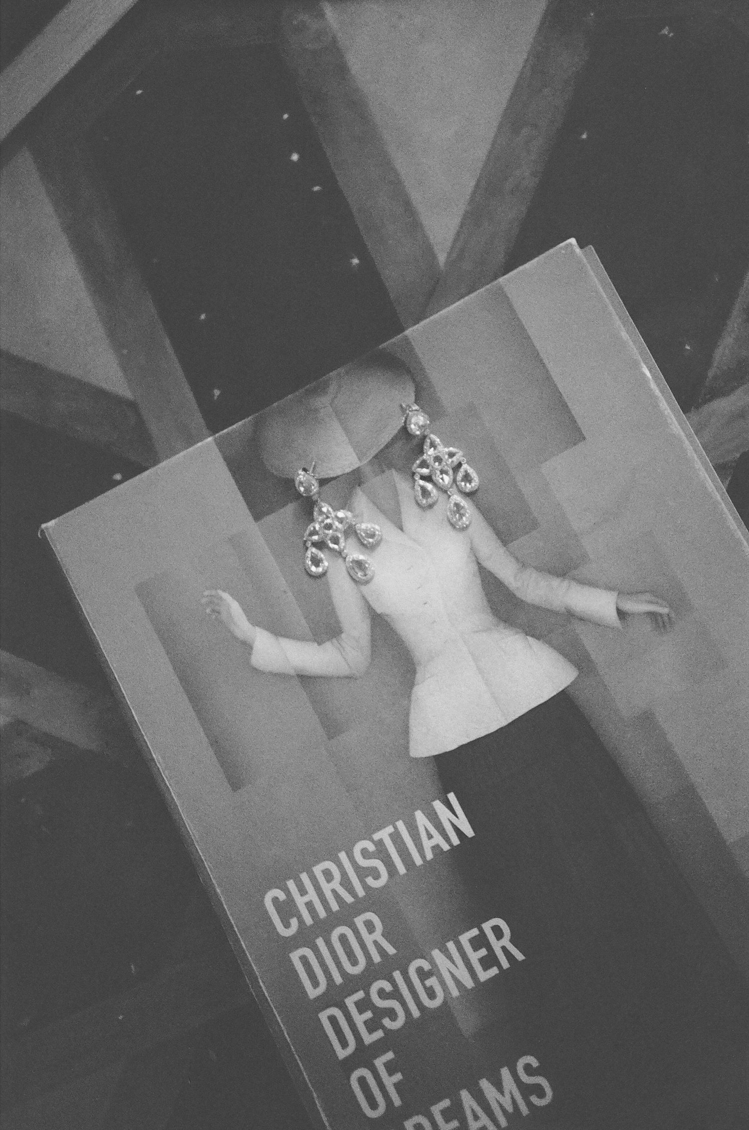 A black and white sequence showing text being revealed on a book cover or document with Christian Dior branding.