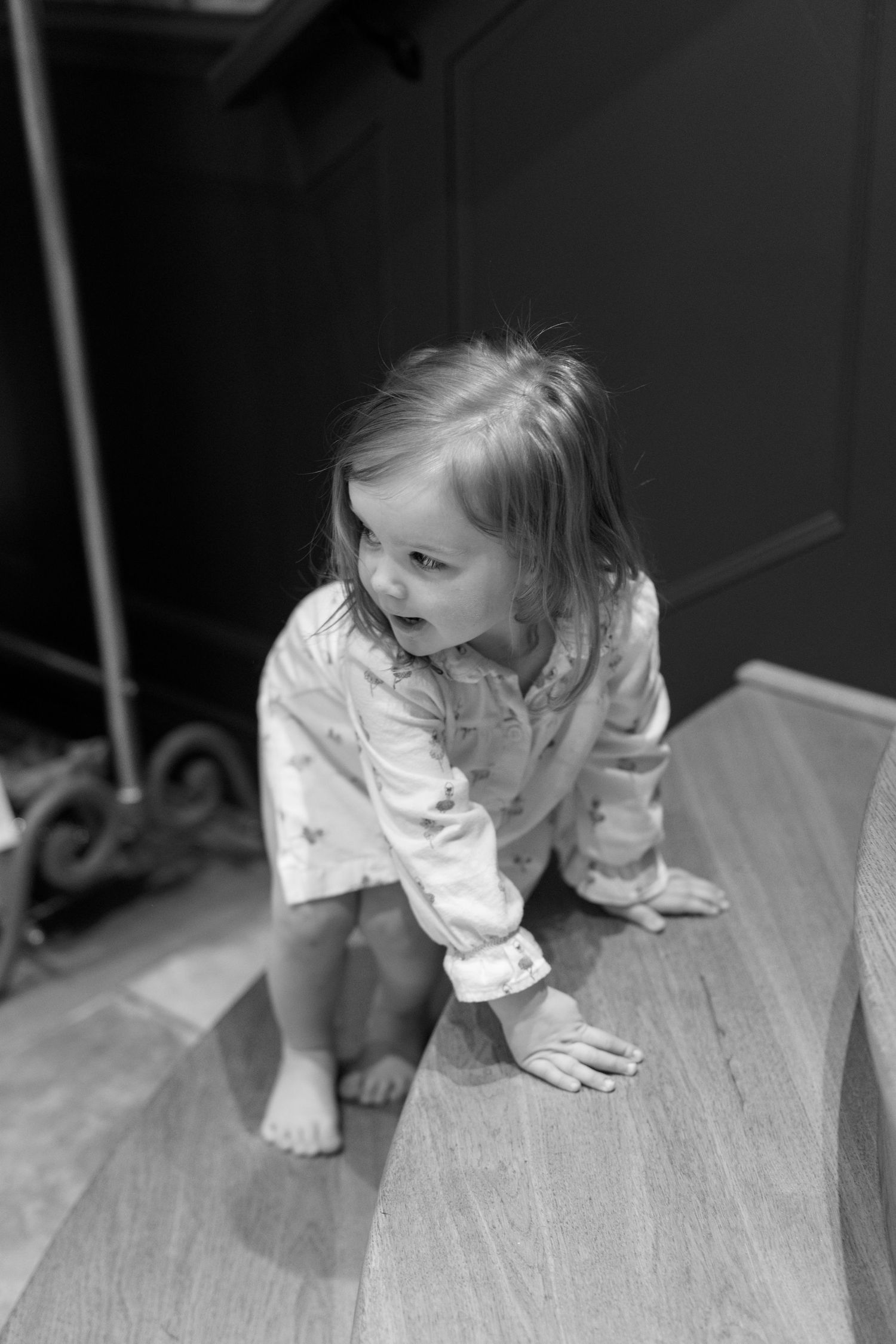 Black and white images of a child crawling on a textured surface.