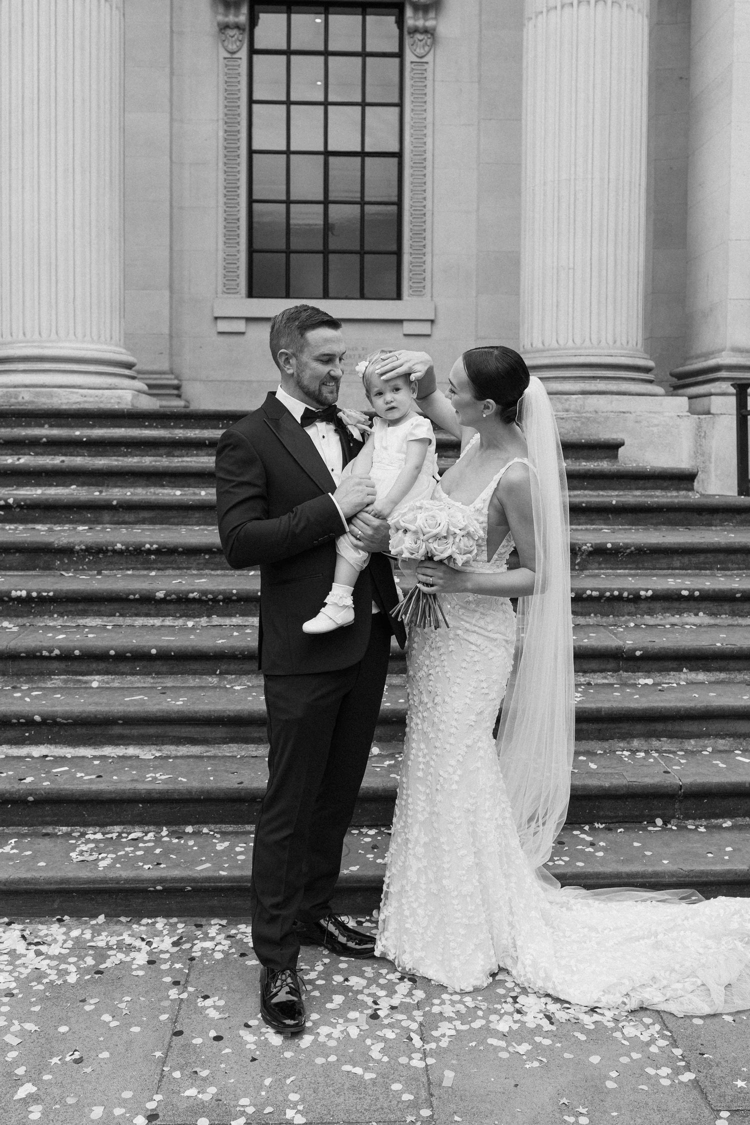 Wedding sequence showing a couple sharing a moment on the steps of a grand building.