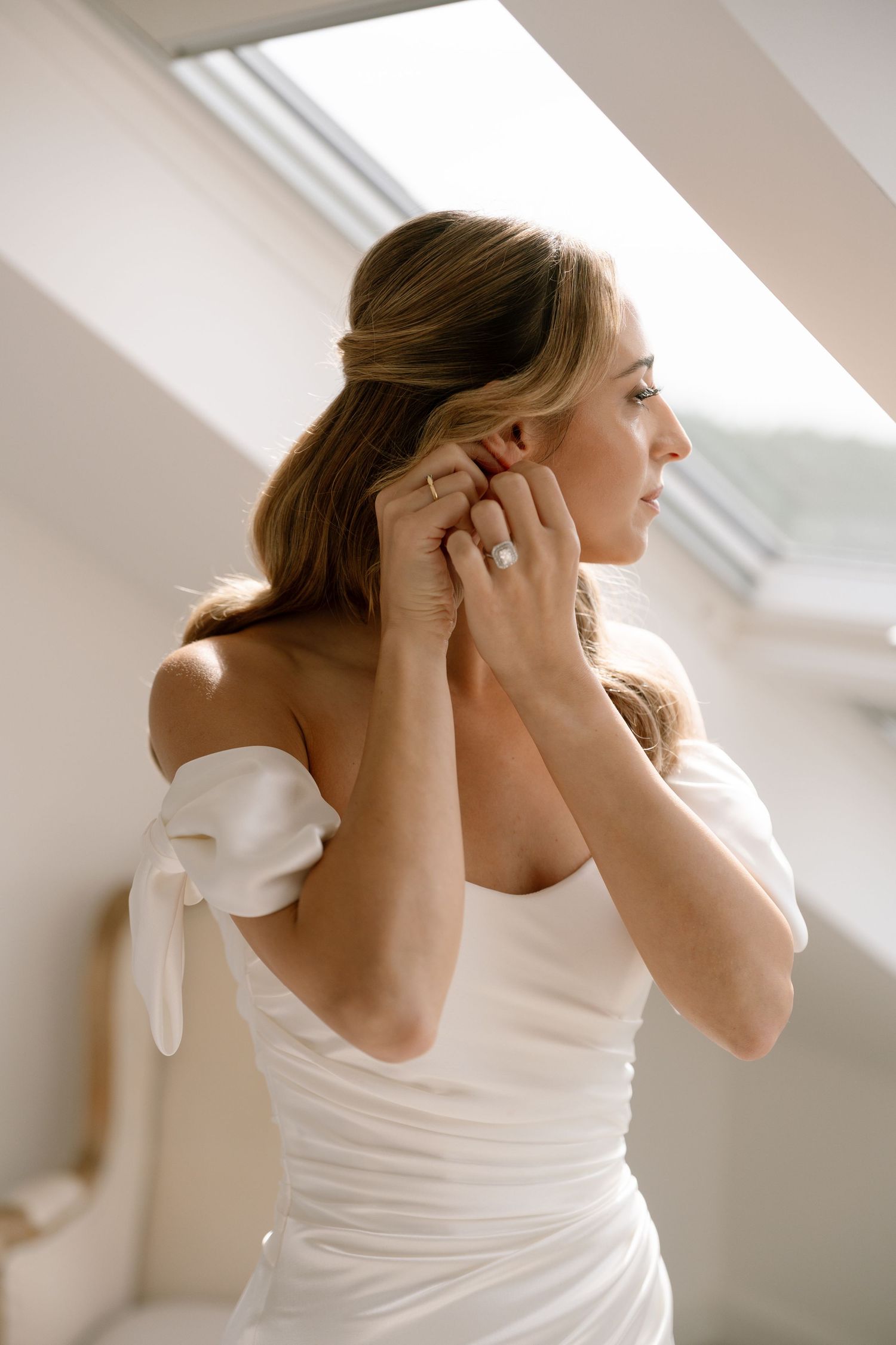 Multiple frames of jewelry and accessory preparation in sunlit white room.