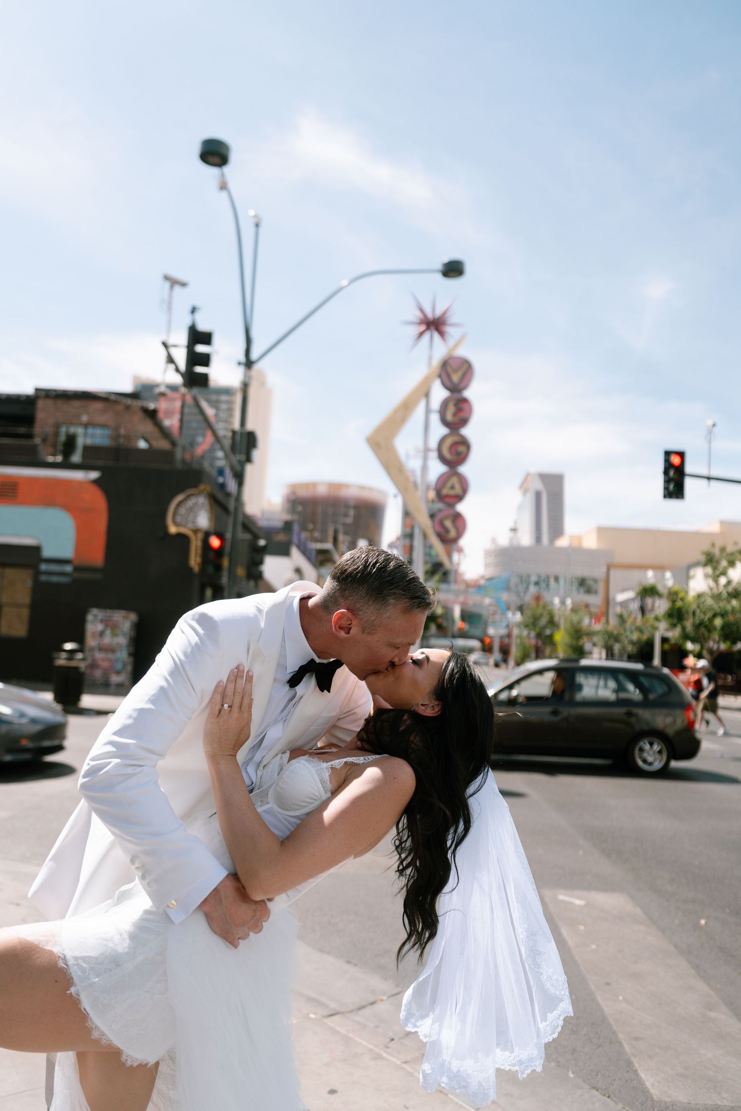 Romantic dance dip sequence photographed on a sunny downtown street corner.