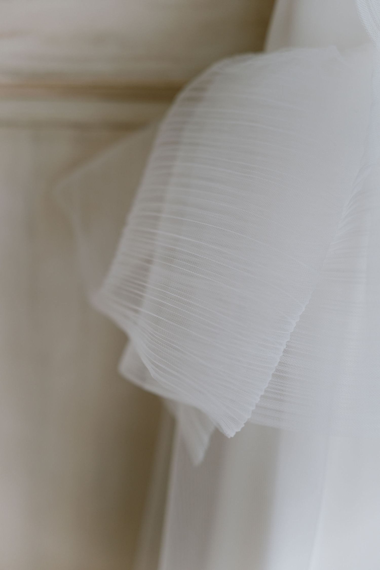 Close-up of delicate white tulle fabric with soft focus.