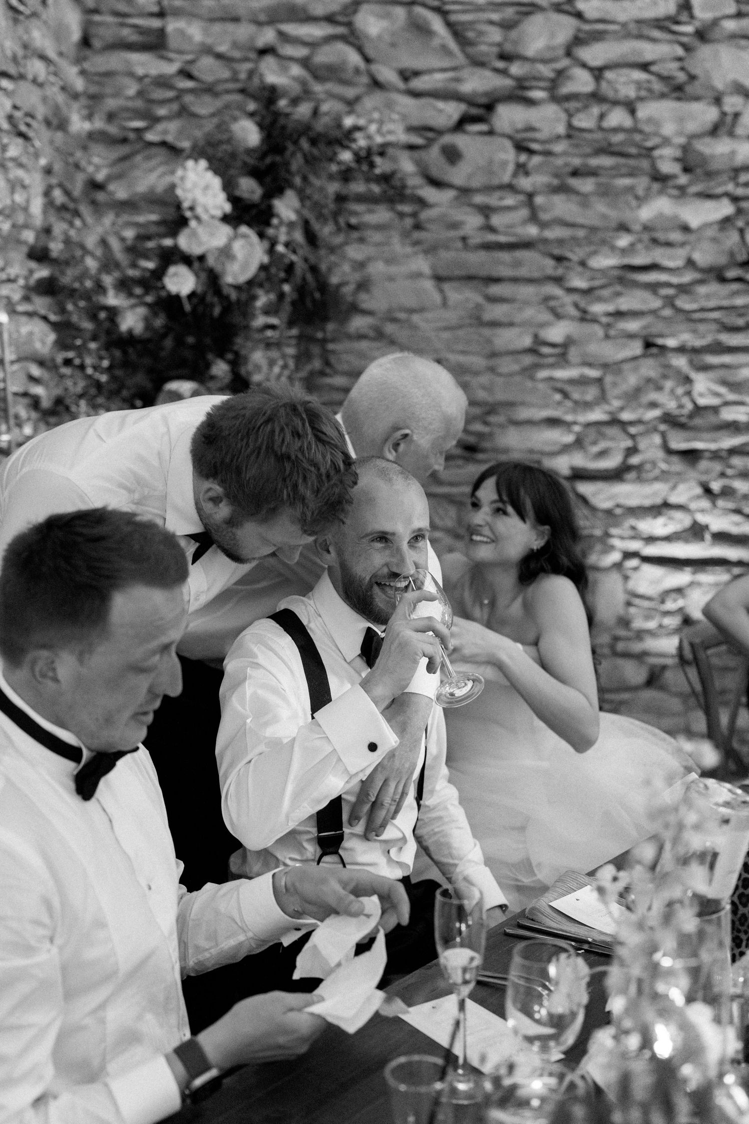 Candid moment of guests sharing laughter at an elegant wedding reception.