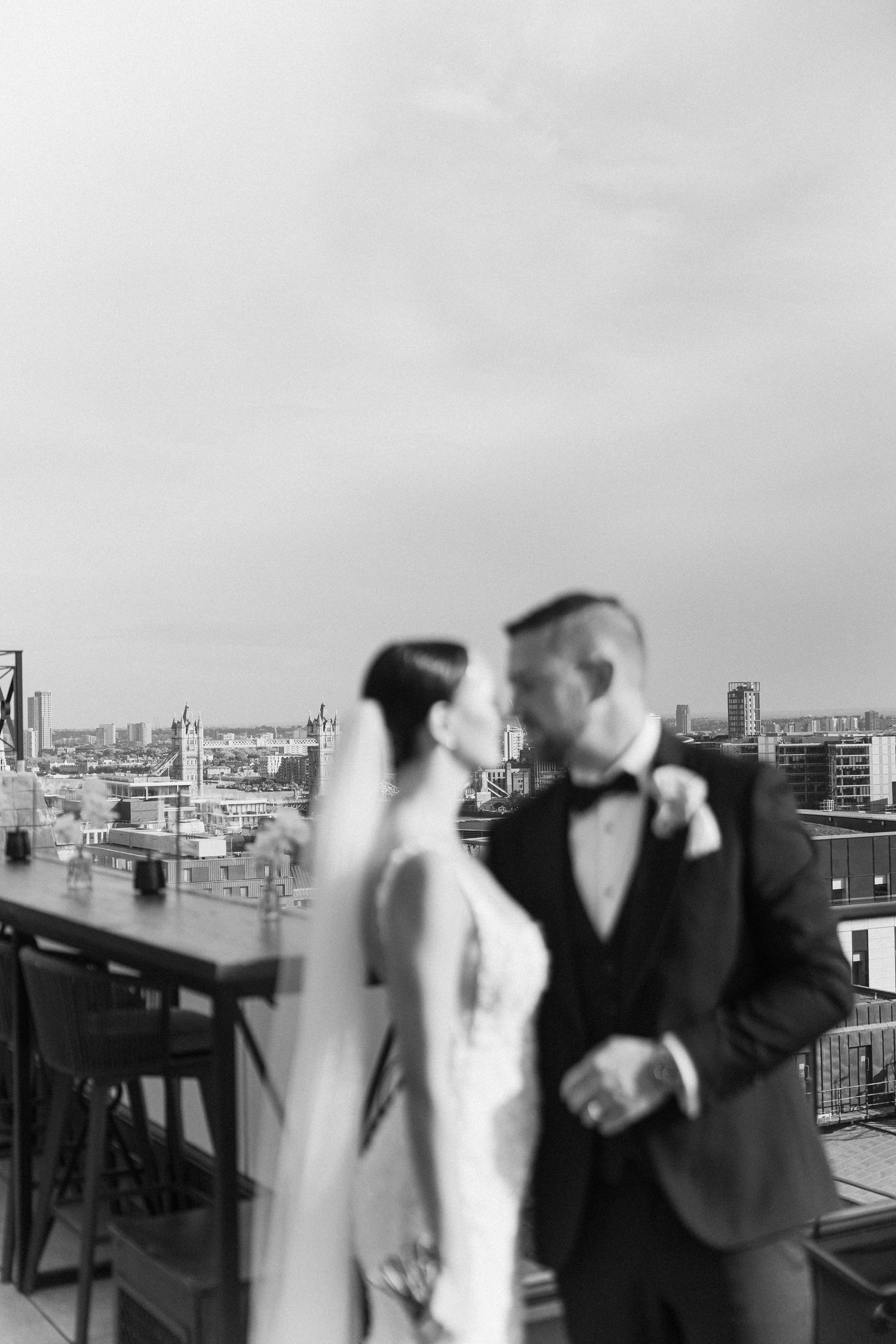 A wedding celebration on a London rooftop with city views in the background.