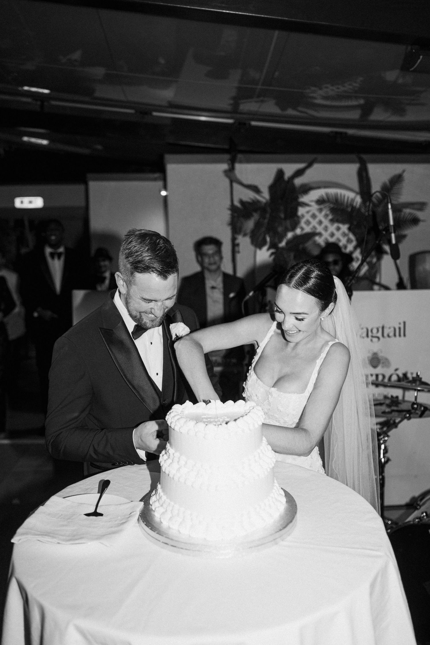 Intimate moment of a couple preparing to cut their wedding cake at their reception.
