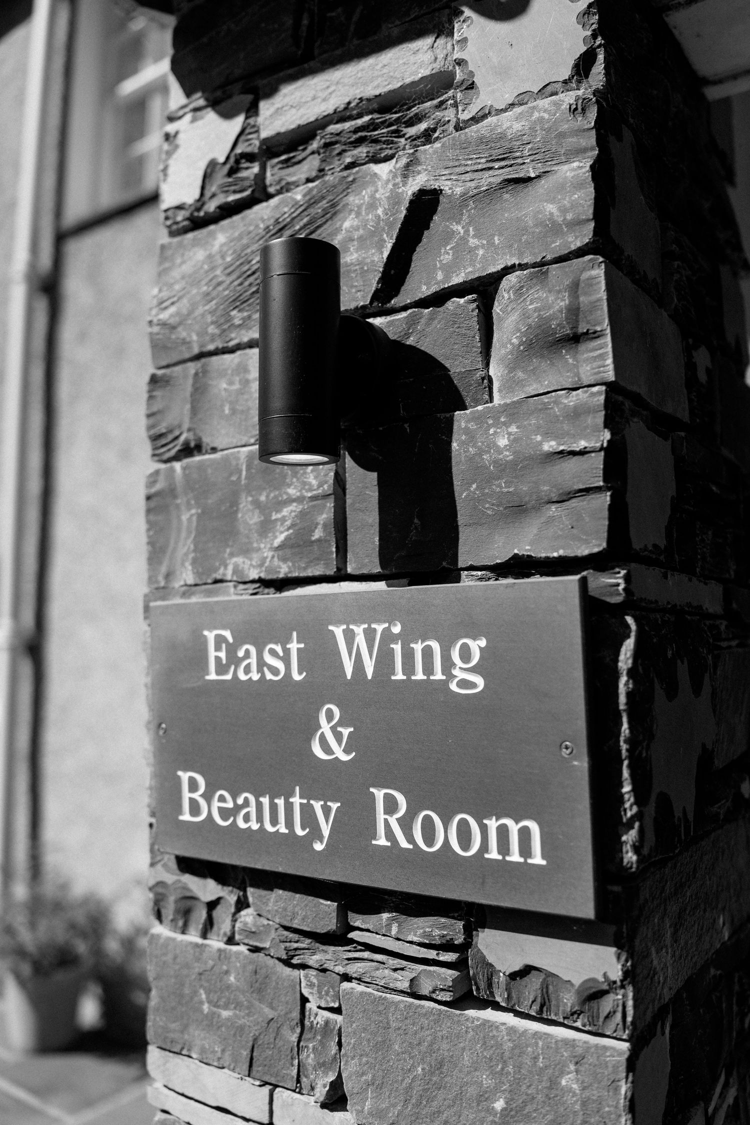 Stone wall with signage reading East Wing and Beauty Room.
