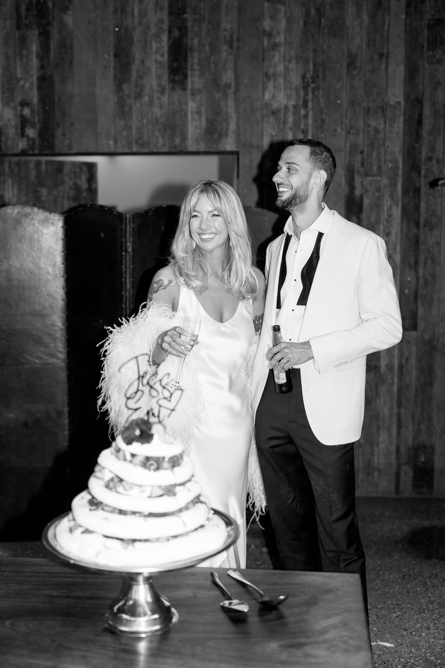 A couple cuts their wedding cake together at their reception.