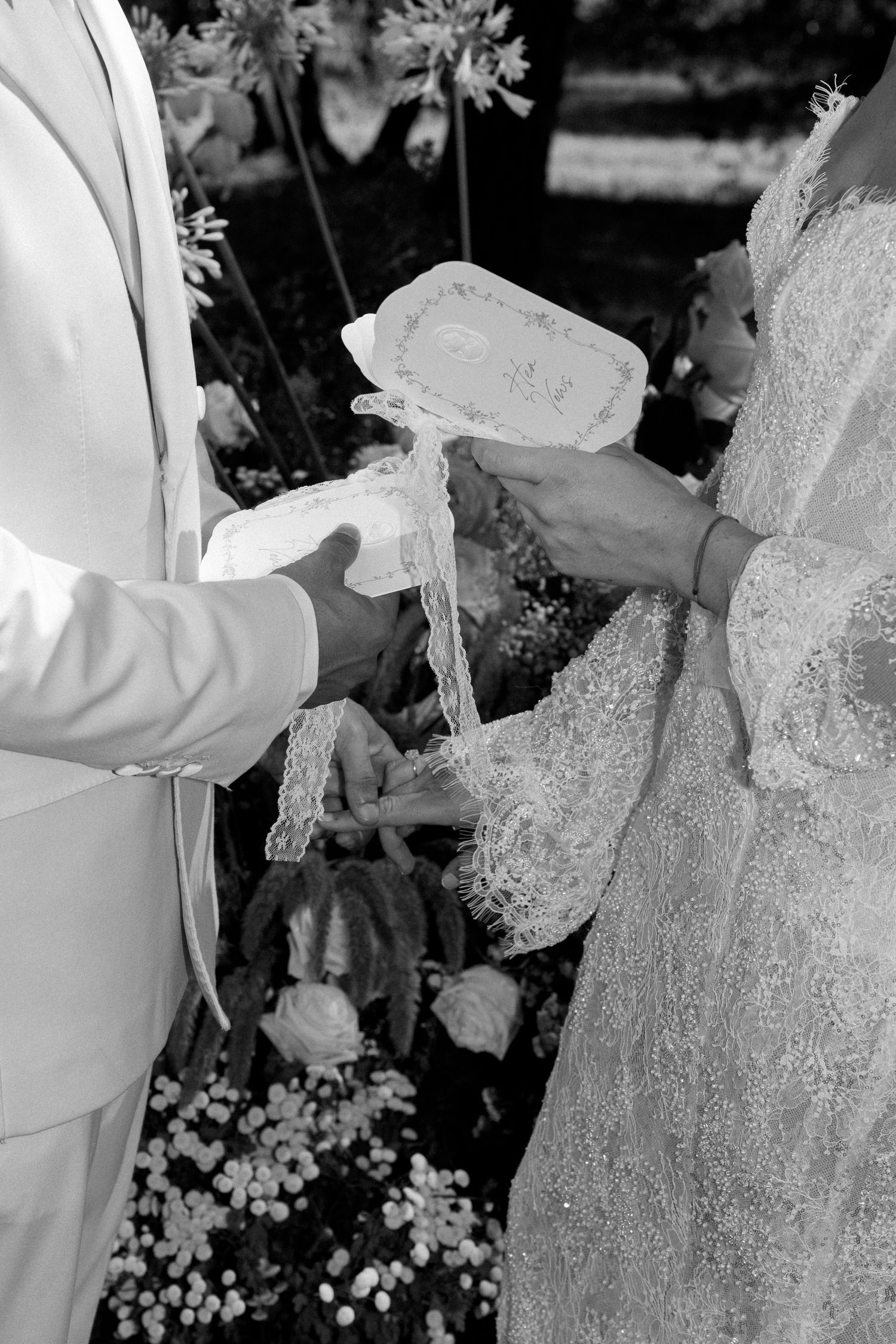 Black and white sequence showing details of lace and fabric being handled.