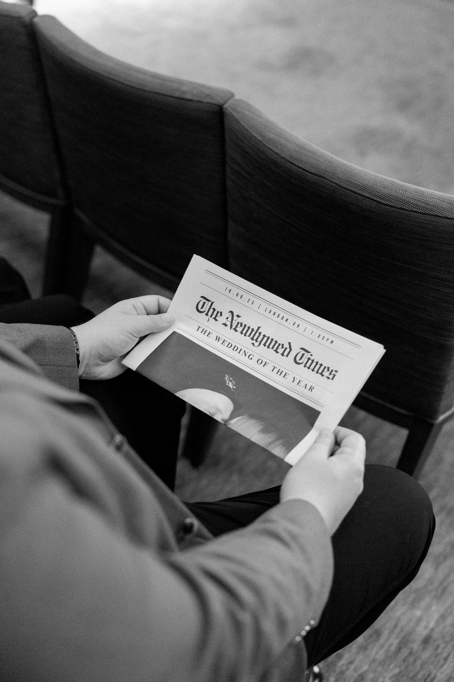 Close-up sequence of hands holding and reading The New York Times newspaper.
