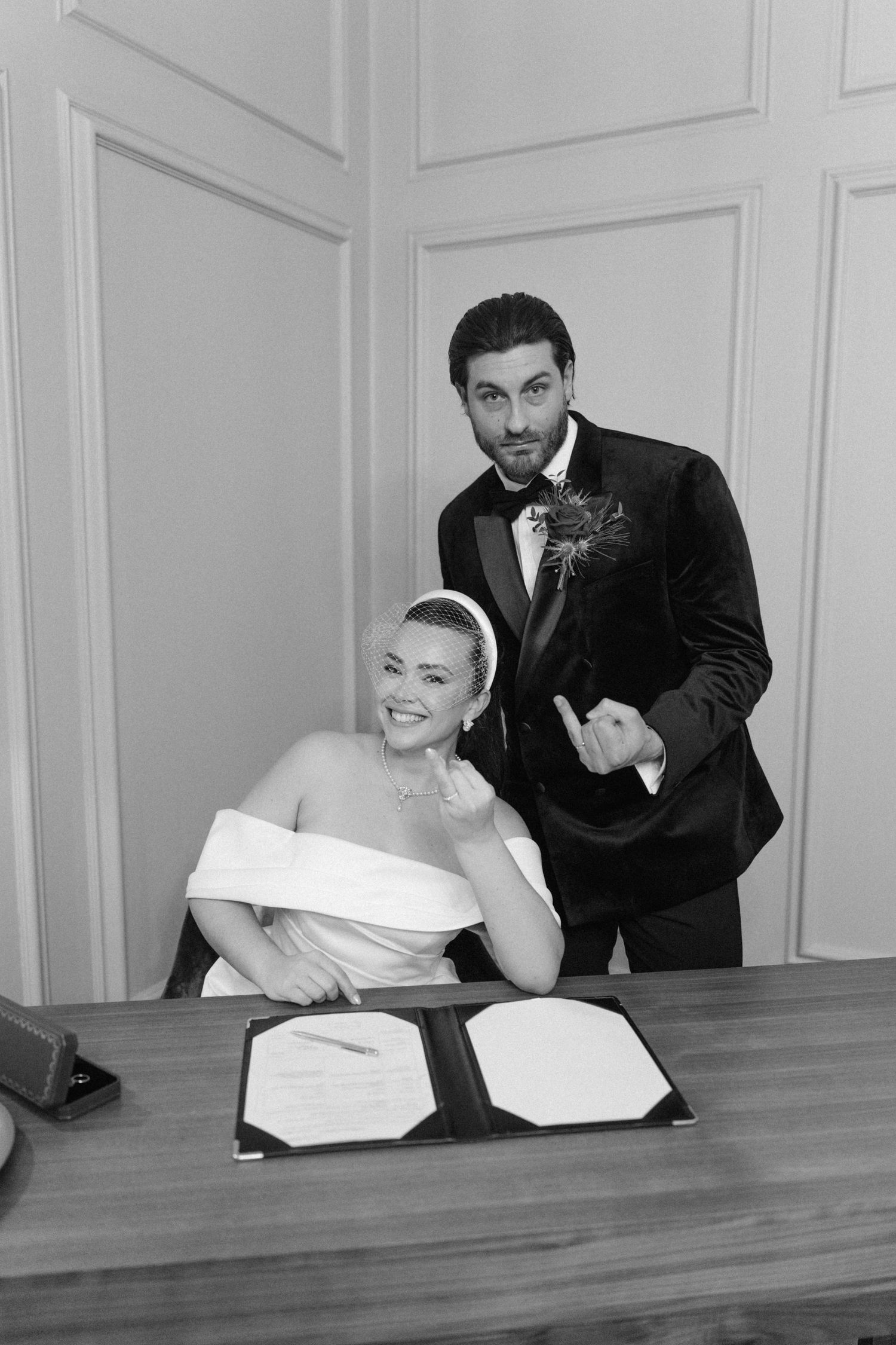 Candid sequence of newlyweds sharing intimate moments at a wooden table in formal attire.